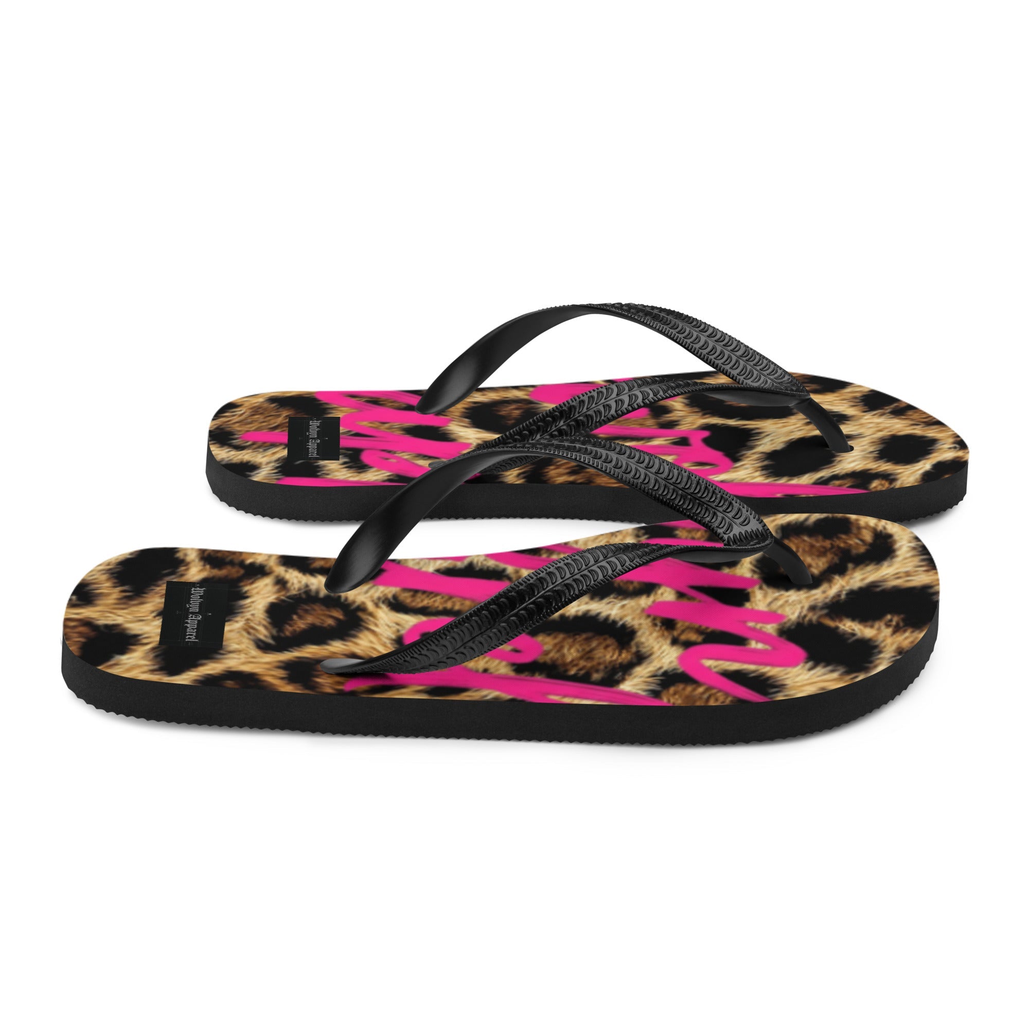 Leopard print flip flops with black straps and bold pink lettering, streetwear style