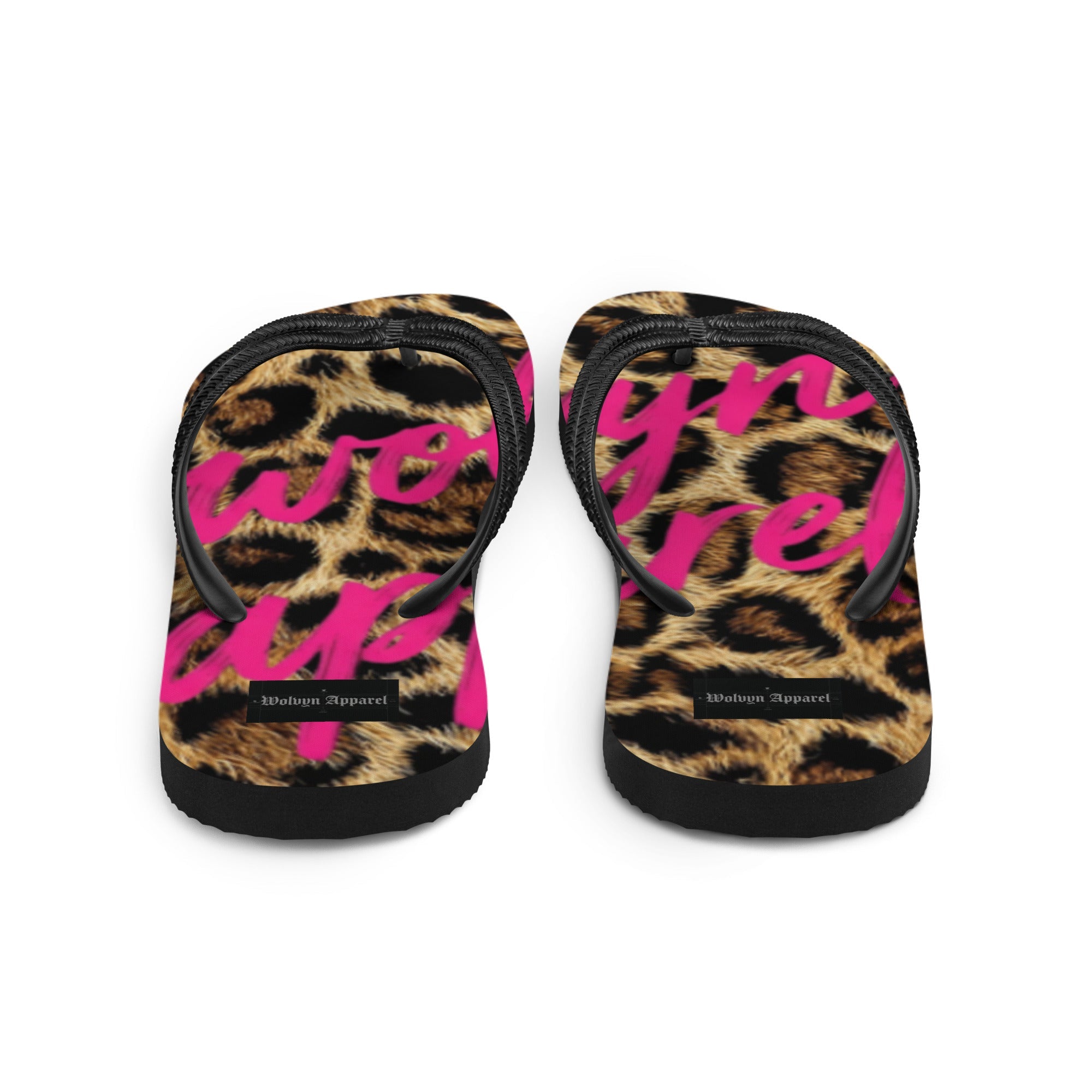 Leopard print flip flops with black straps and bold pink lettering on footbeds