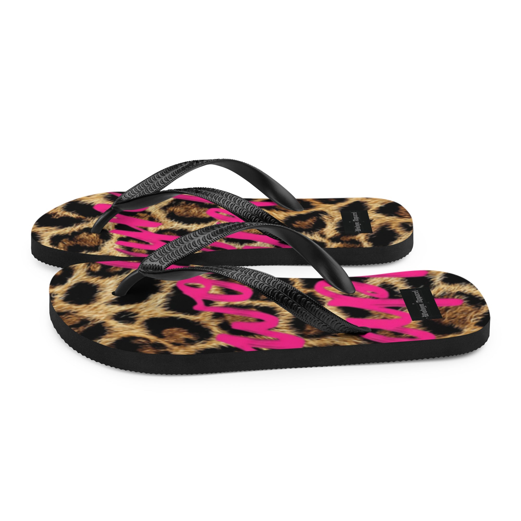 Leopard print flip flops with black straps and bold pink lettering, stylish streetwear footwear