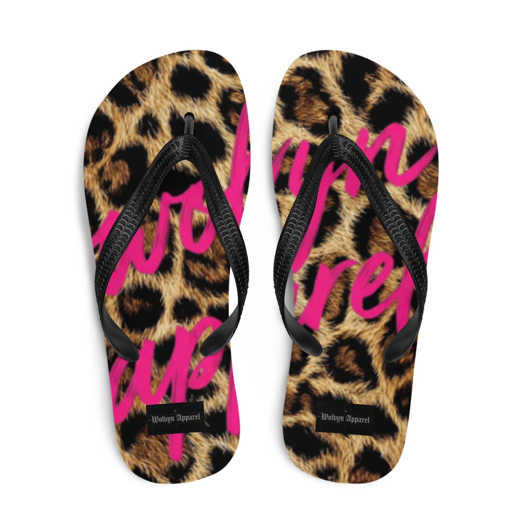 Leopard print flip flops with bold pink lettering and black straps, streetwear style
