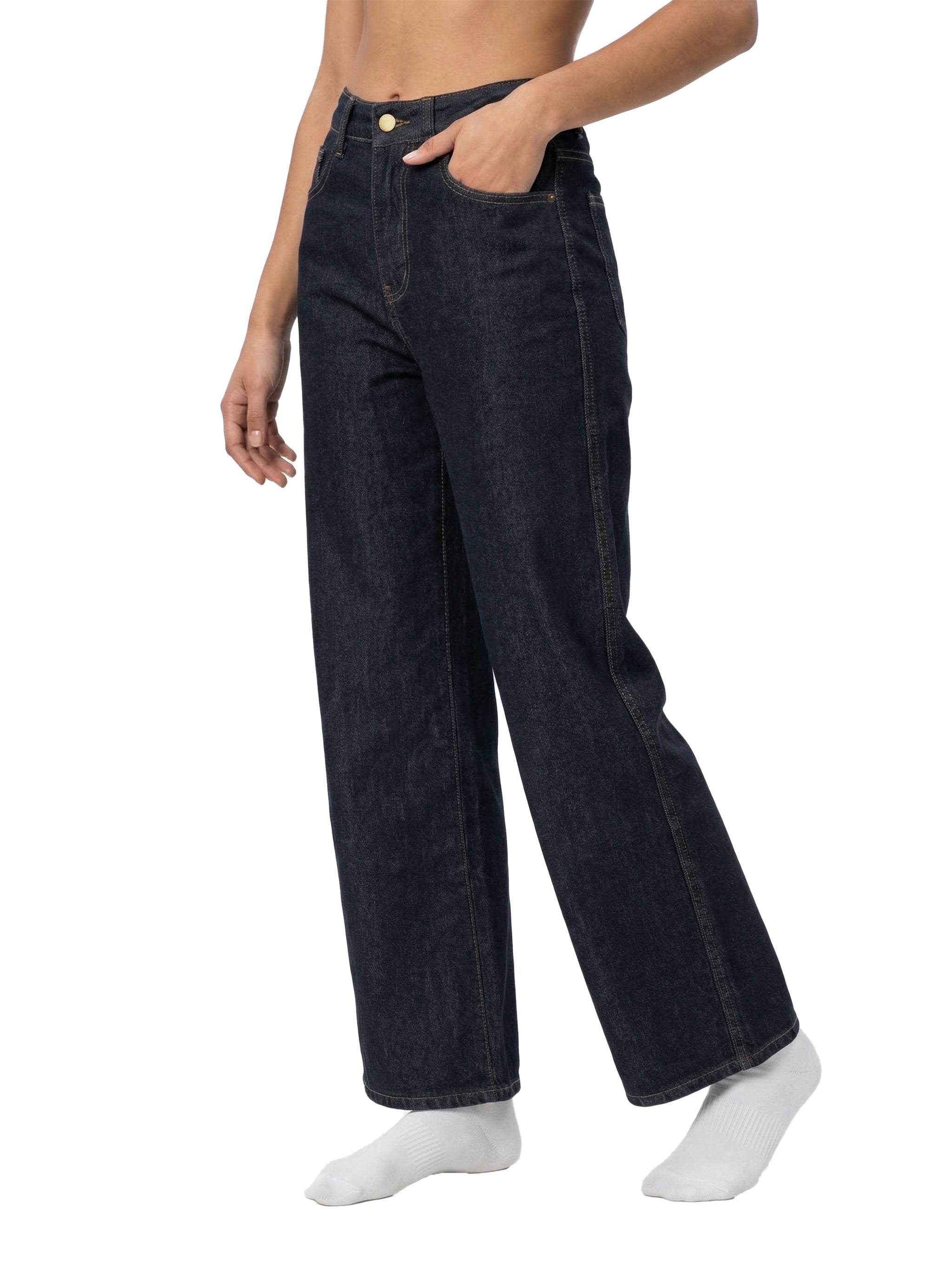 Woman wearing high-waisted, straight-leg dark denim jeans against white background