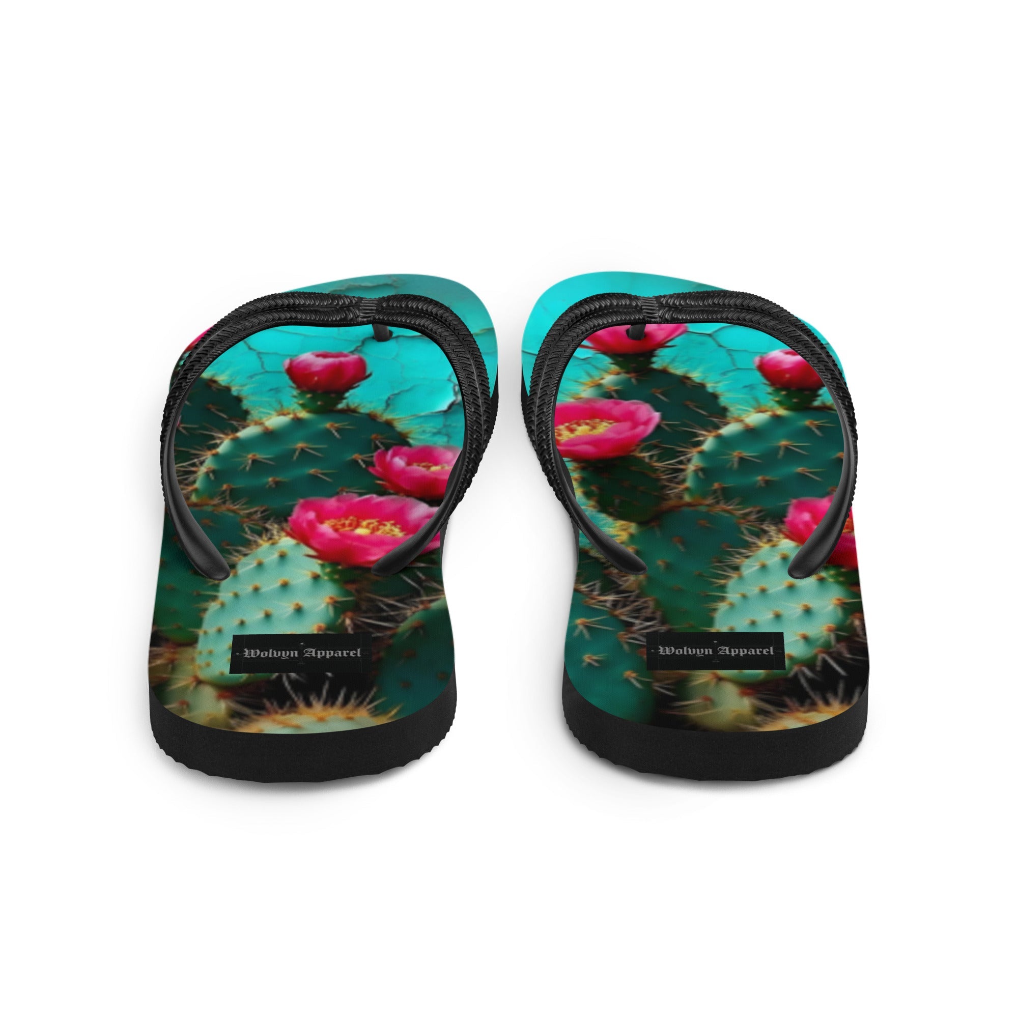 Flip flops with cactus and pink flower print, black straps, turquoise background