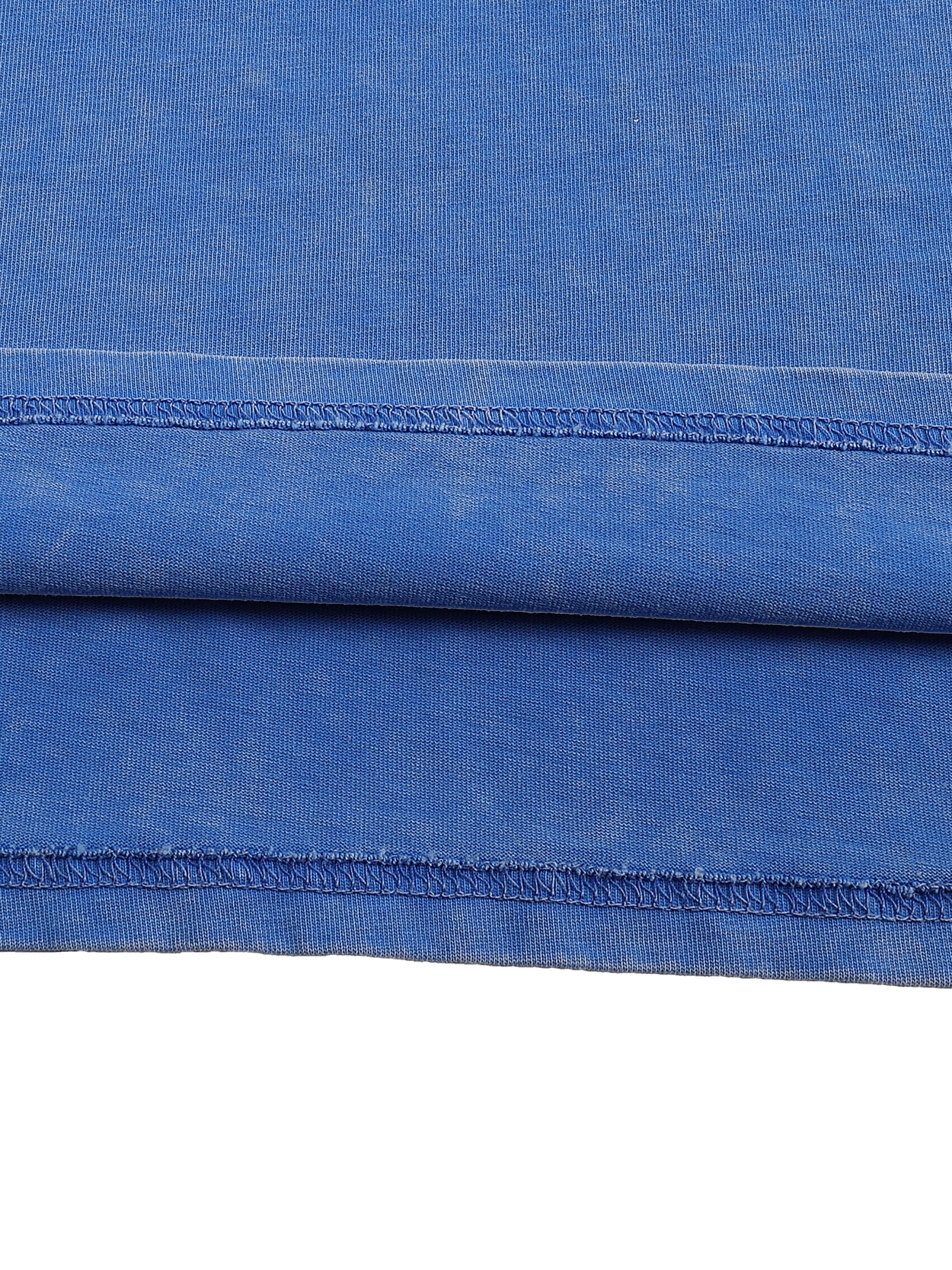 Close-up of blue snow-washed oversized cotton t-shirt fabric and seam detail
