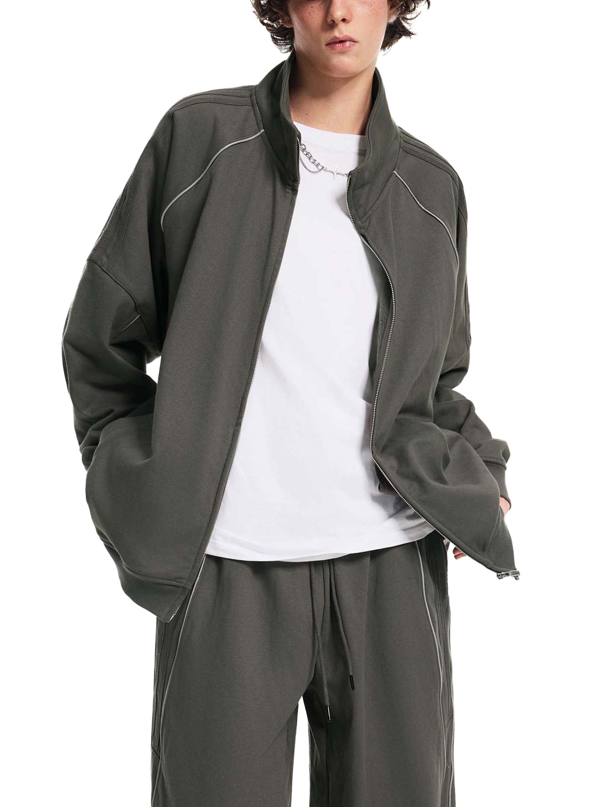 Model wearing a dark gray striped raglan sleeve jacket with matching pants, streetwear style