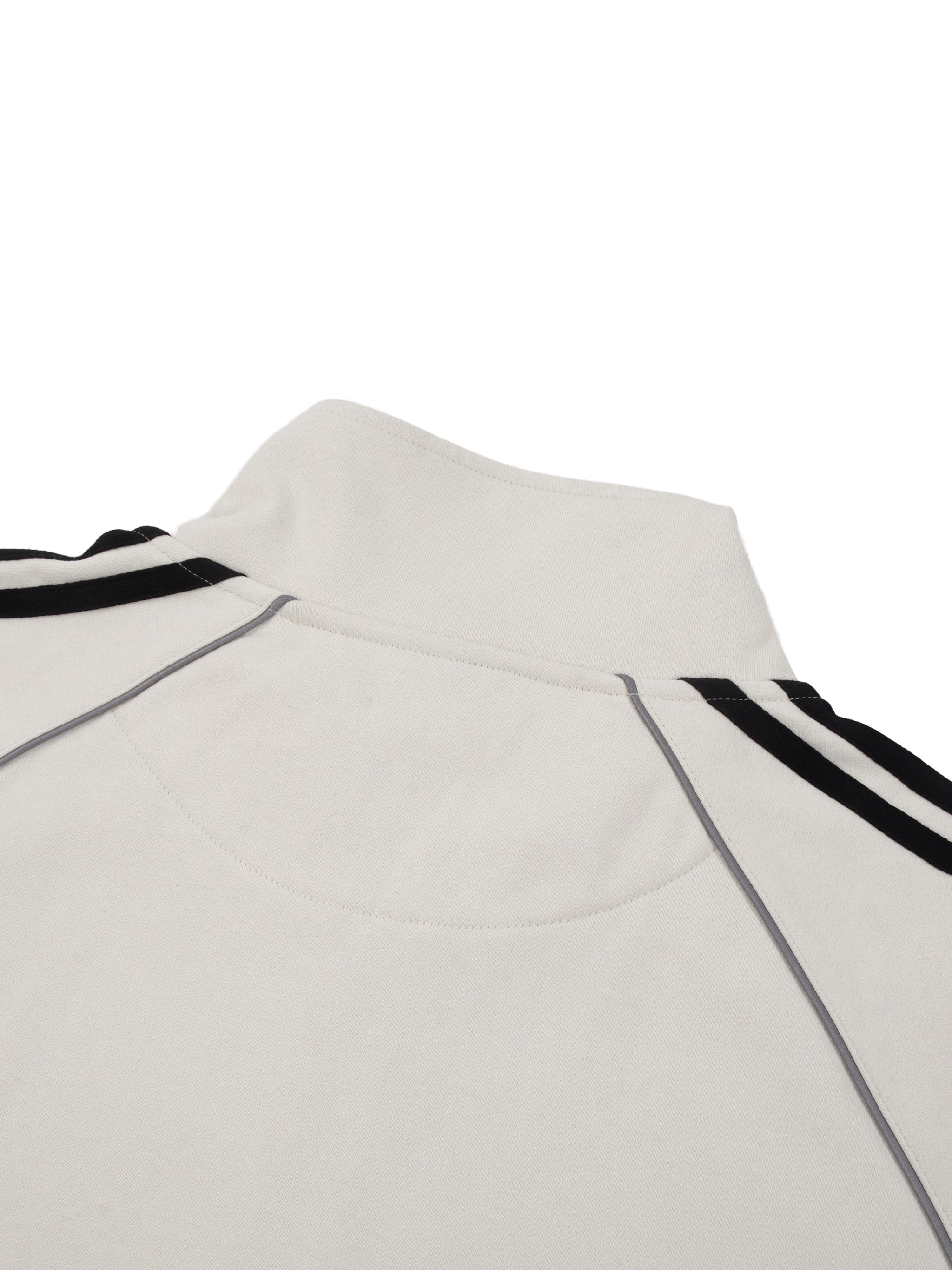 Back view of white raglan sleeve jacket with black stripes and piped seams