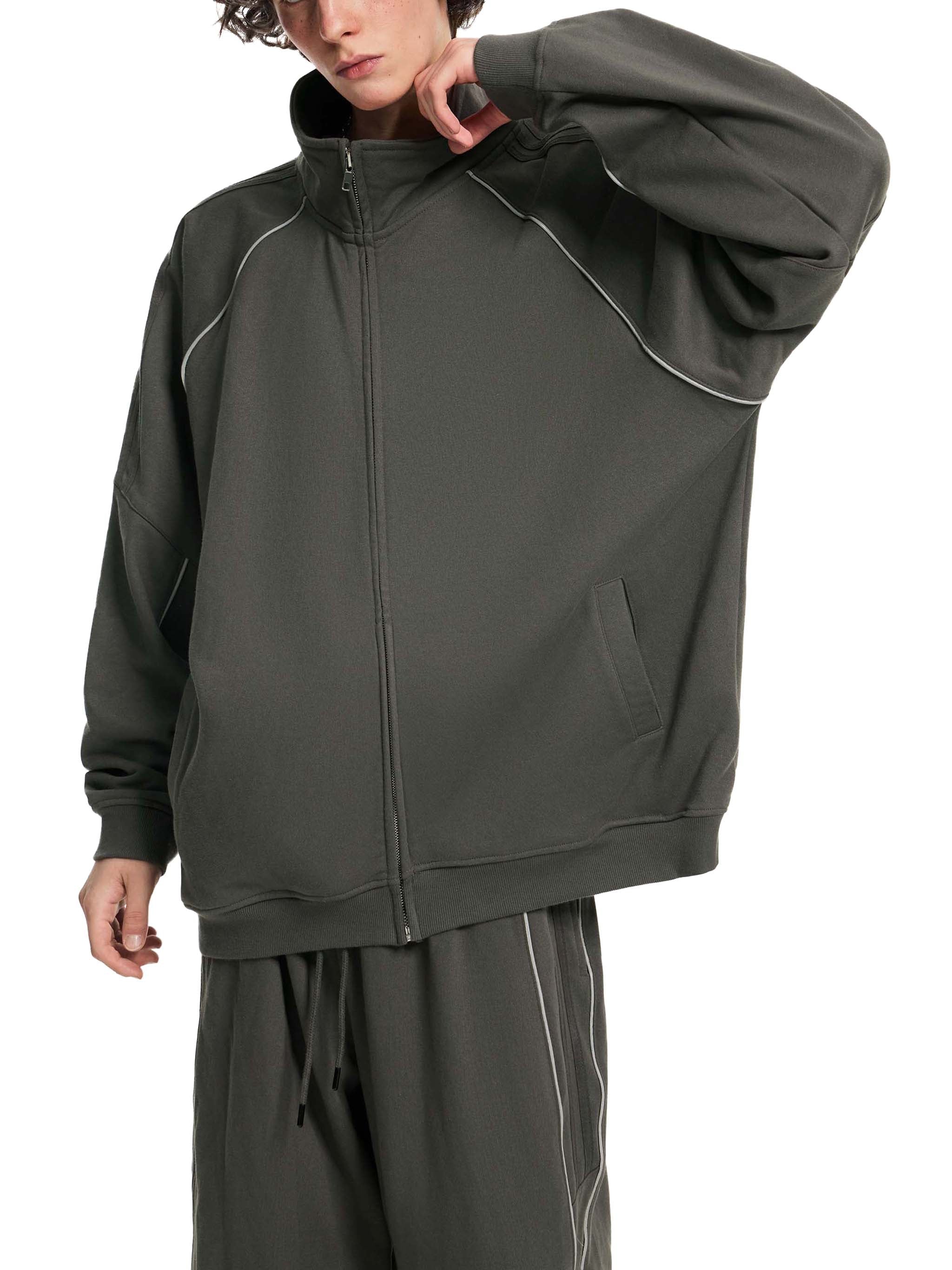 Oversized dark gray raglan sleeve jacket with white piping, zip front, and pockets
