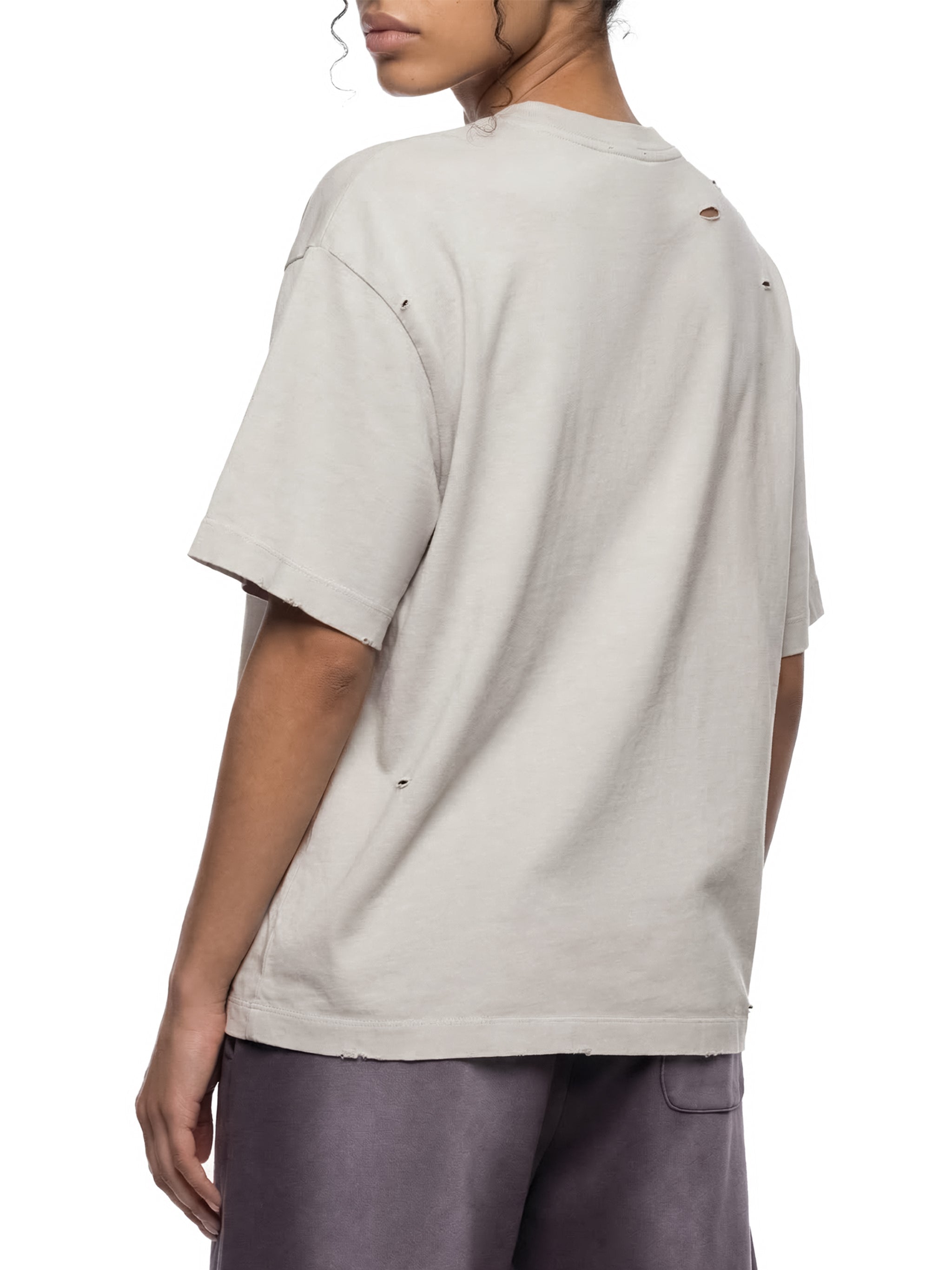 Back view of vintage washed oversized distressed t-shirt with subtle rips and boxy fit