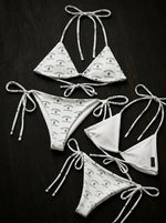 White Scottsdale cactus print string bikinis with tie straps on dark background
