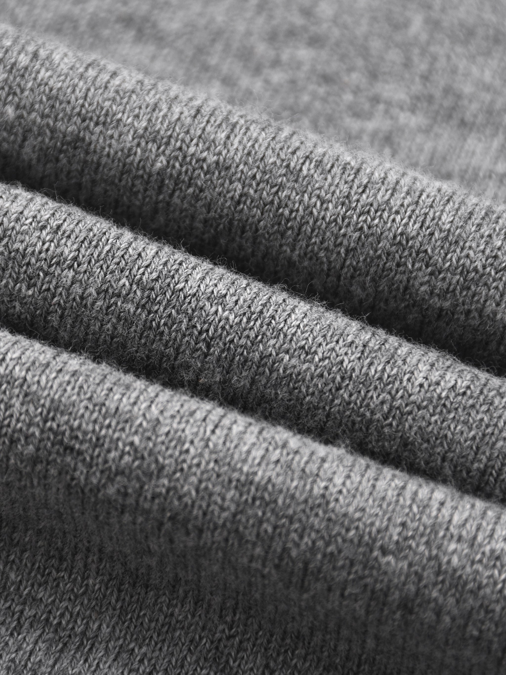 Close-up of soft, heavyweight grey cotton knit fabric for short sleeve Henley t-shirt.