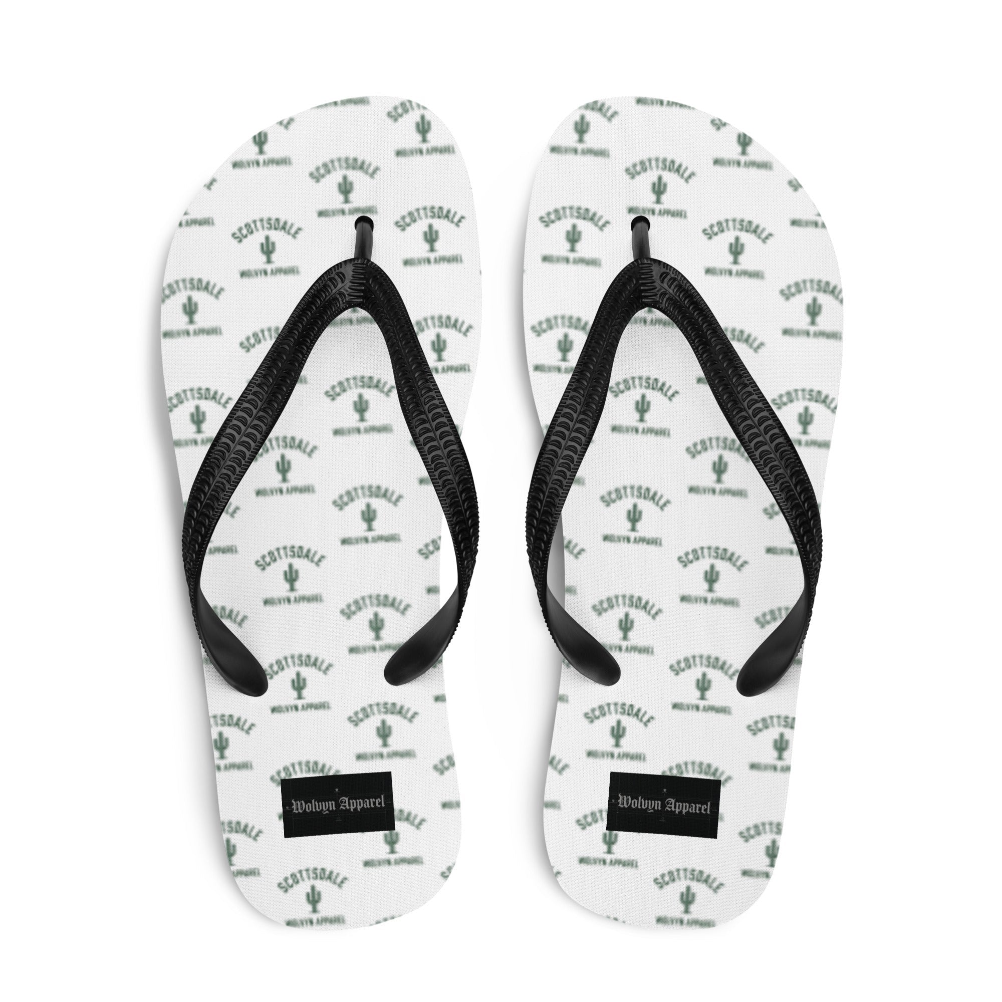 White flip flops with black straps, green Scottsdale cactus print, Wolvyn Apparel label on sole