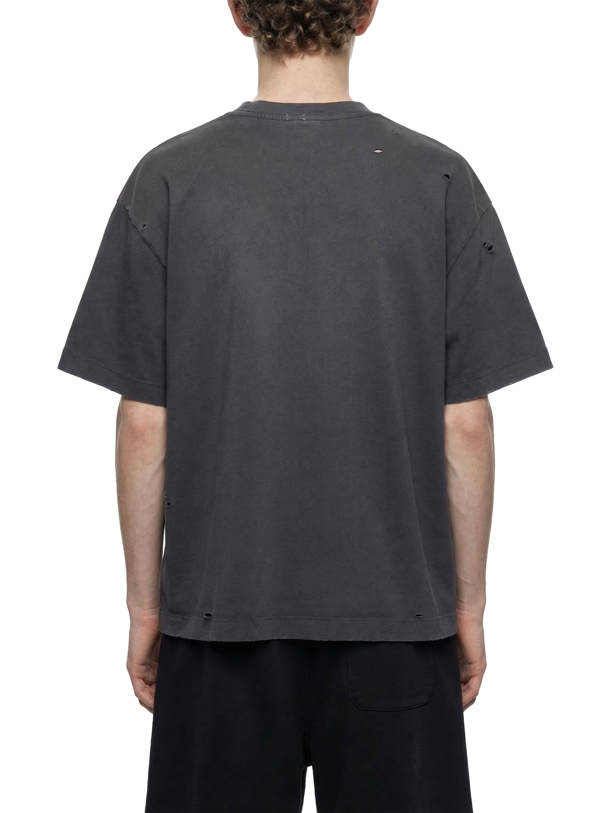 Back view of vintage washed oversized distressed dark grey t-shirt on model