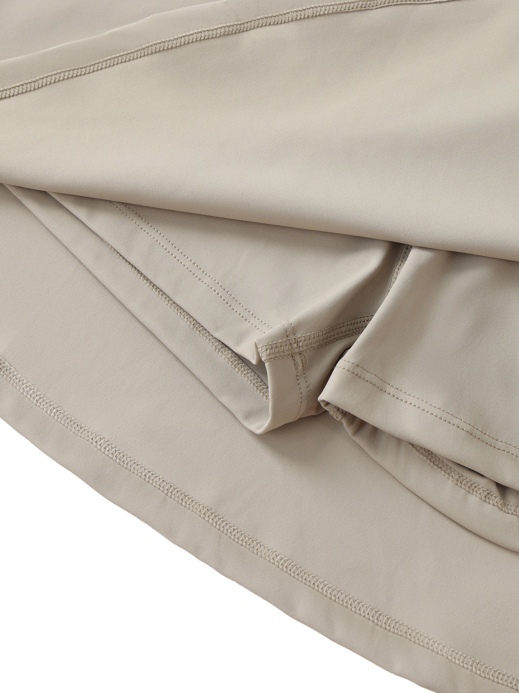 Beige high-waist A-line skirt with stitched hem and hidden pocket detail
