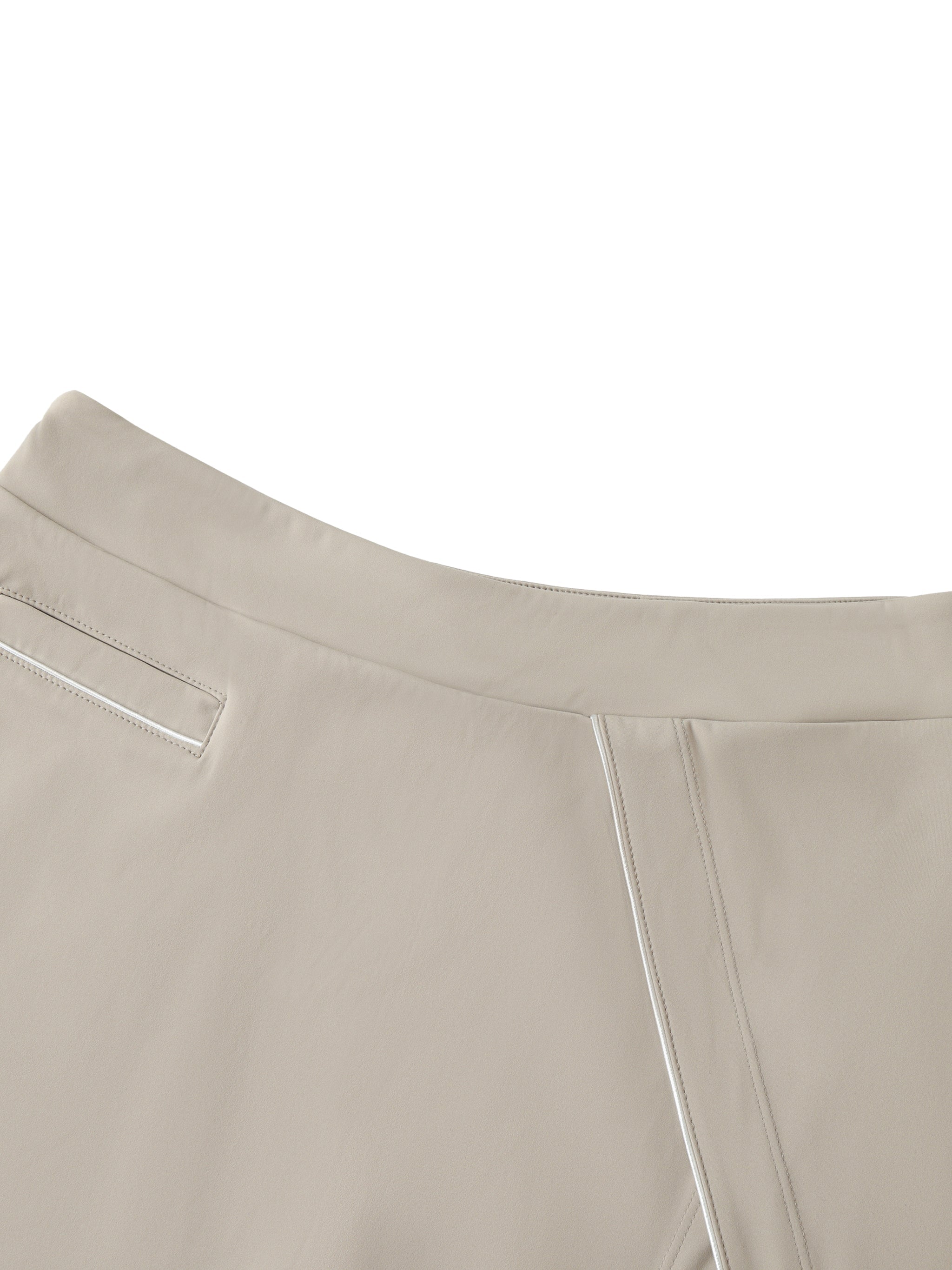 Close-up of beige high-waist A-line skirt with pocket and seam detail