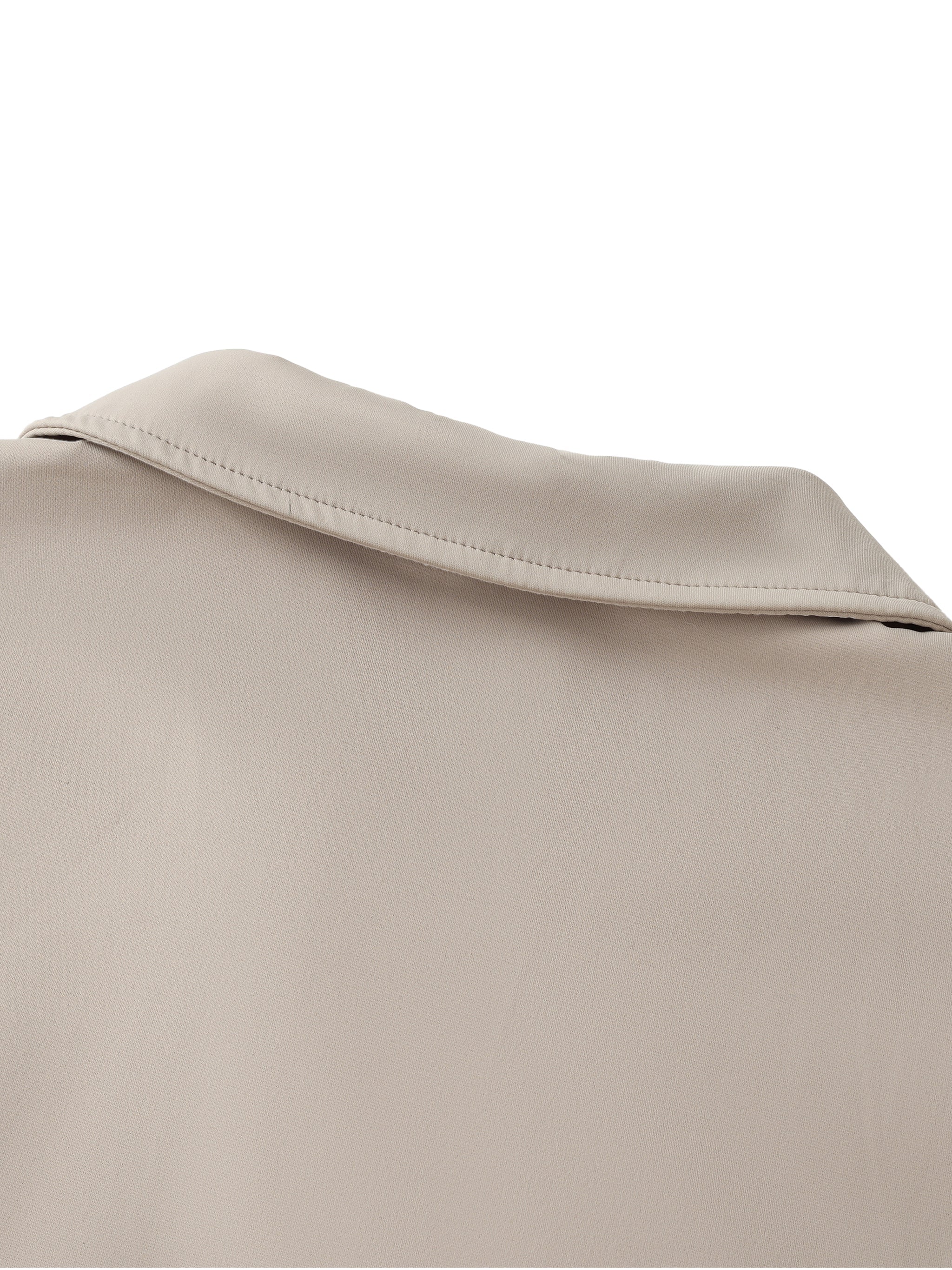 Close-up of beige v-neck lapel crop top collar, soft premium fabric detail