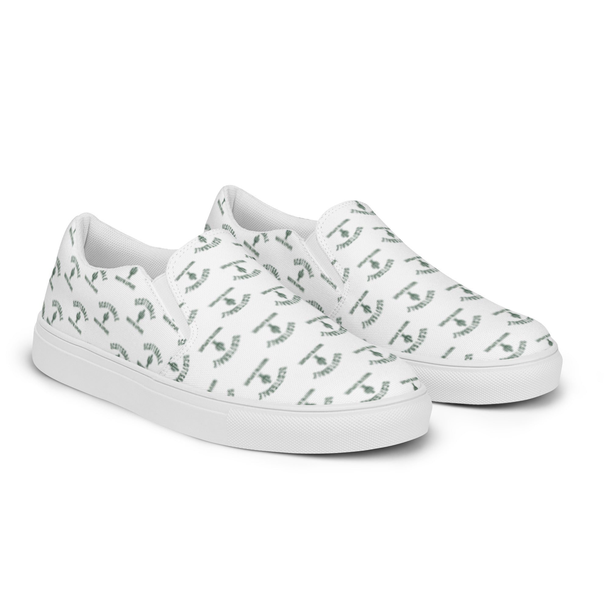 White women's slip-on canvas shoes with green abstract pattern on a plain background