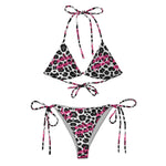 Snow leopard print string bikini with pink script accents on white background