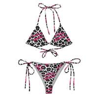 Snow leopard print string bikini with pink script accents on white background