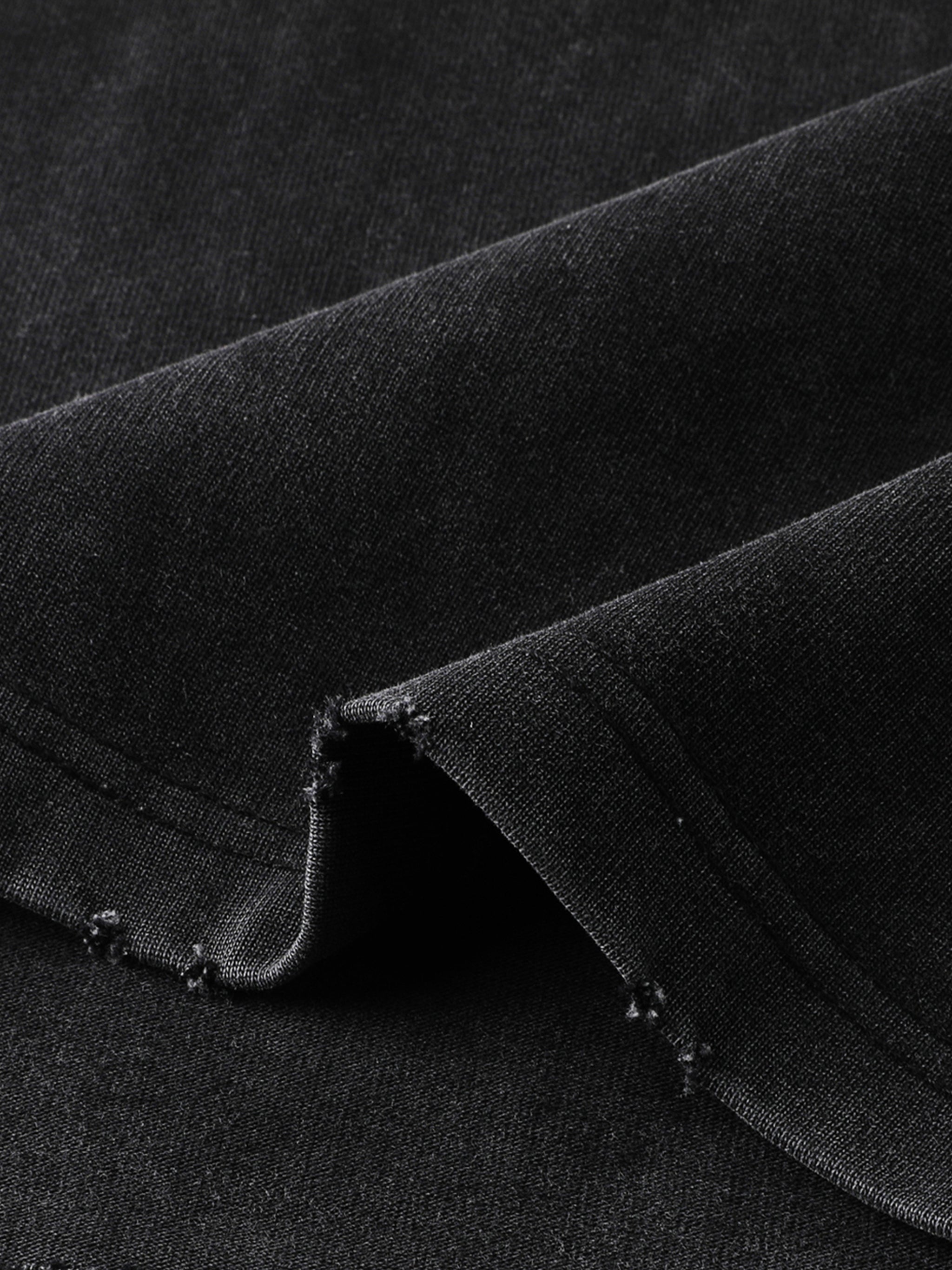 Close-up of heavyweight black vintage washed t-shirt with frayed edges and textured fabric