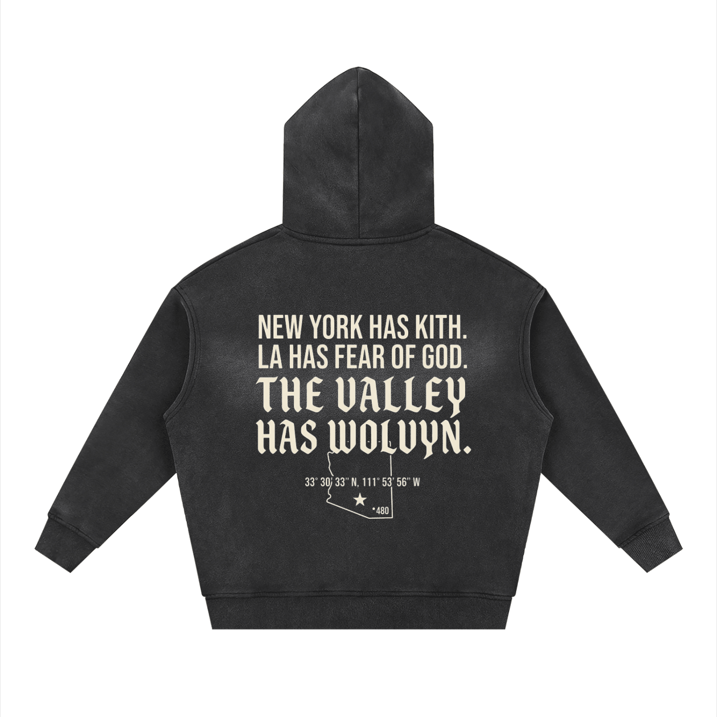 Black boxy fleece hoodie with bold white manifesto text and coordinates on the back