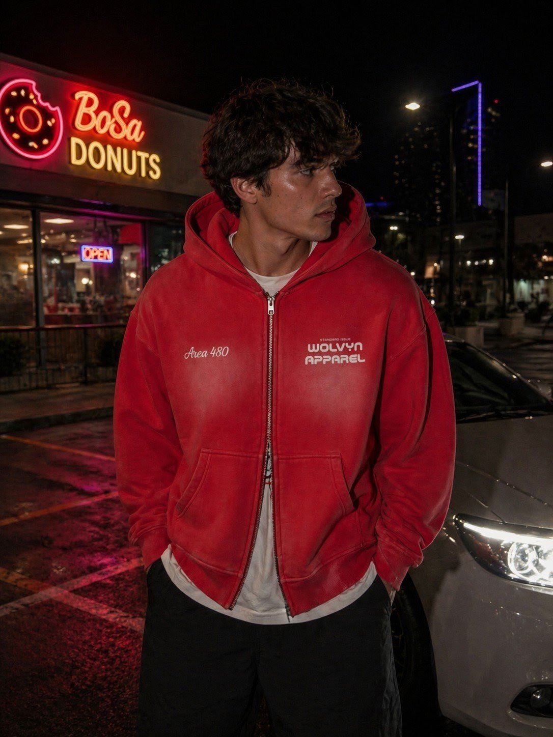 Man wearing red two-way zipper boxy fleece hoodie with streetwear style at night
