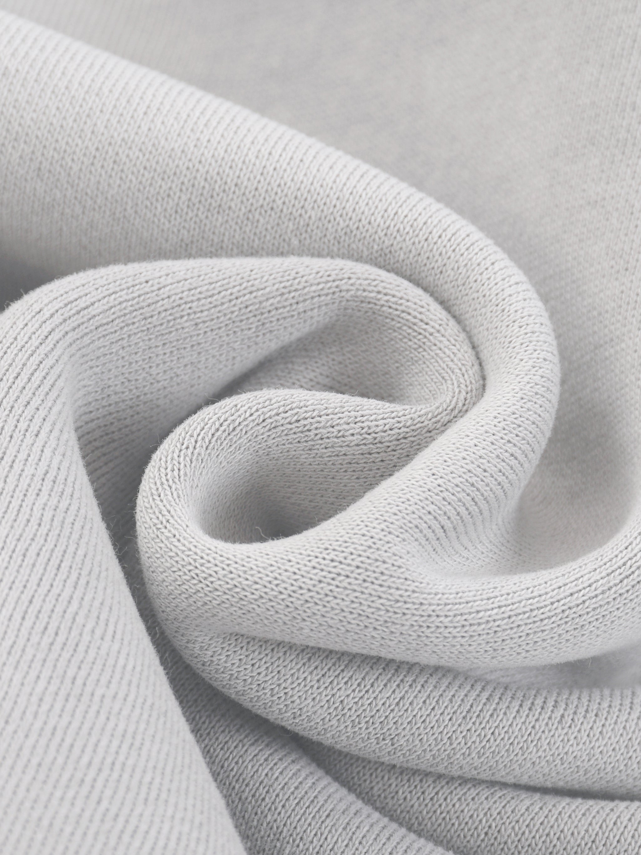 Close-up of soft, heavyweight grey fleece fabric texture, ideal for hoodies and streetwear