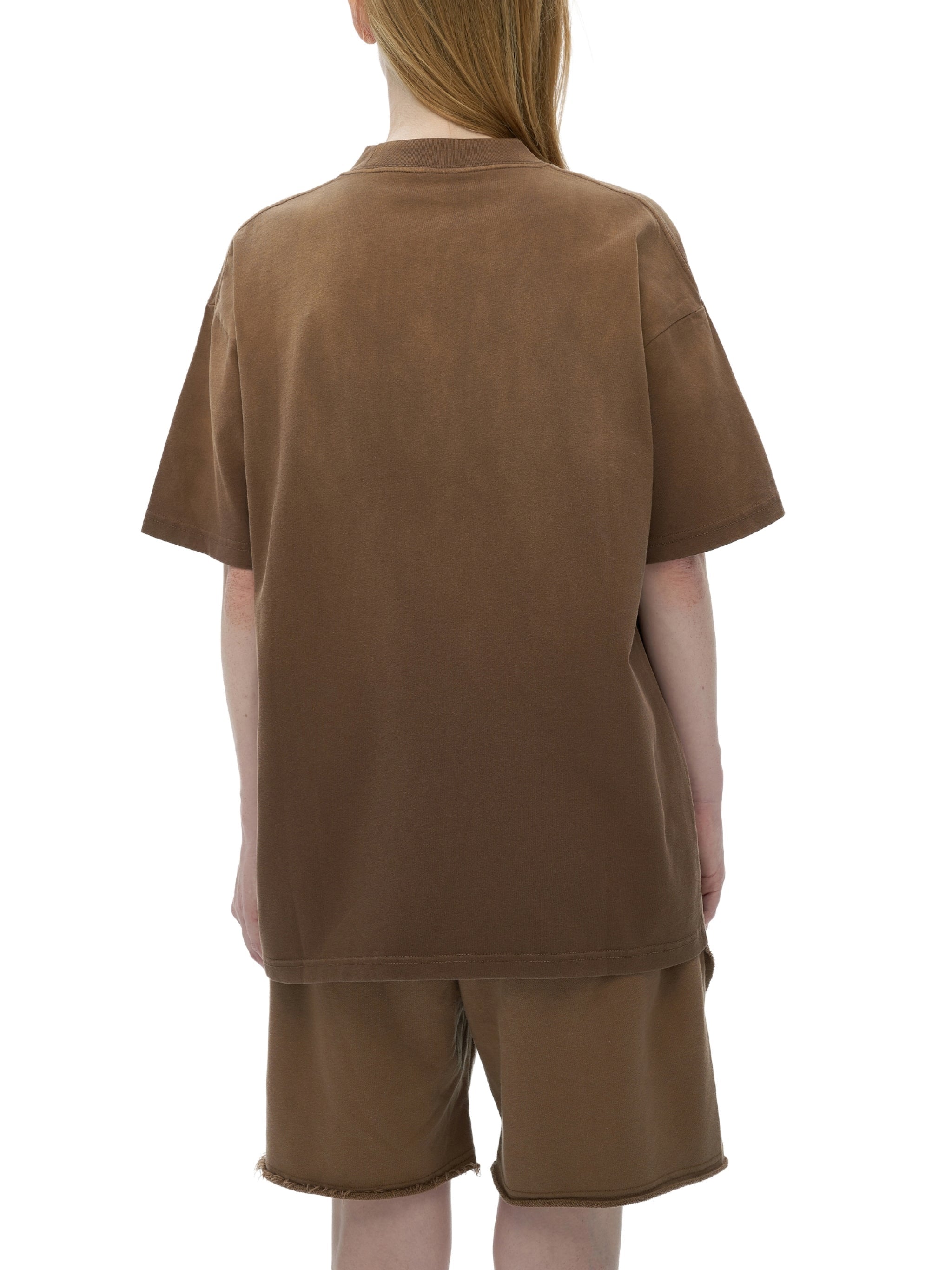 Back view of person wearing oversized brown washed t-shirt and matching shorts