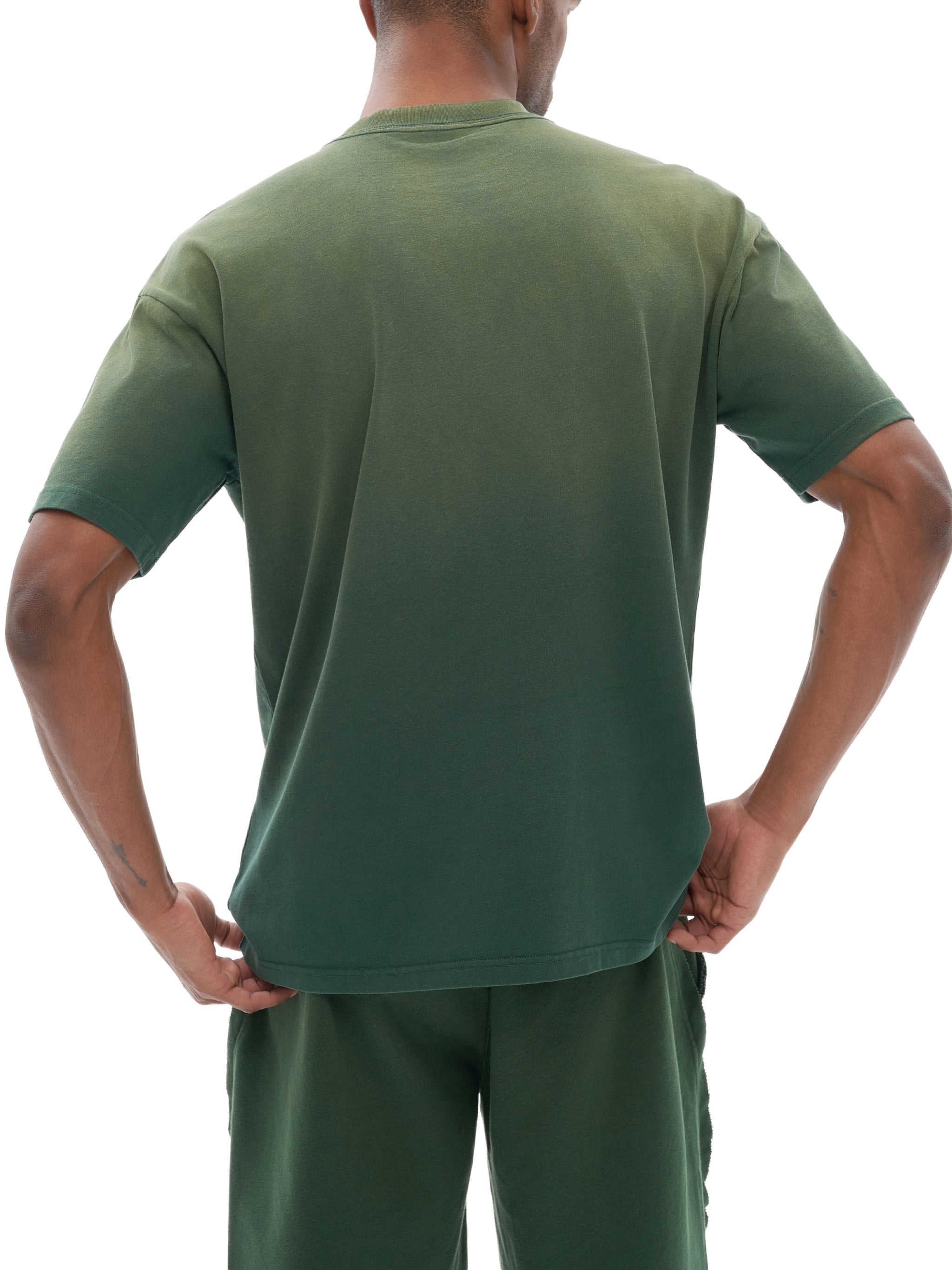 Back view of man wearing green gradient washed t-shirt and matching shorts