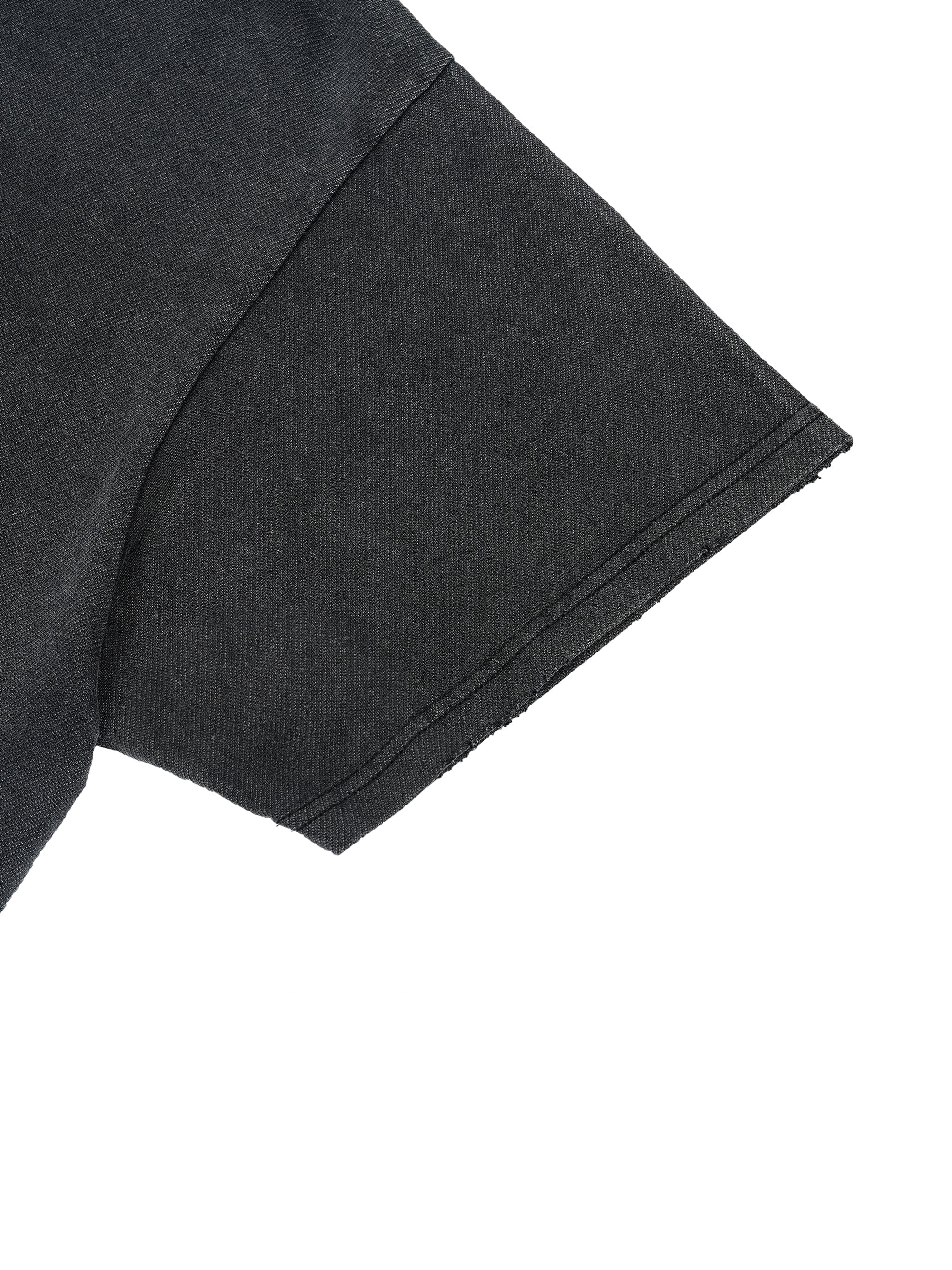 Close-up of black vintage wash t-shirt sleeve with boxy fit and distressed hem
