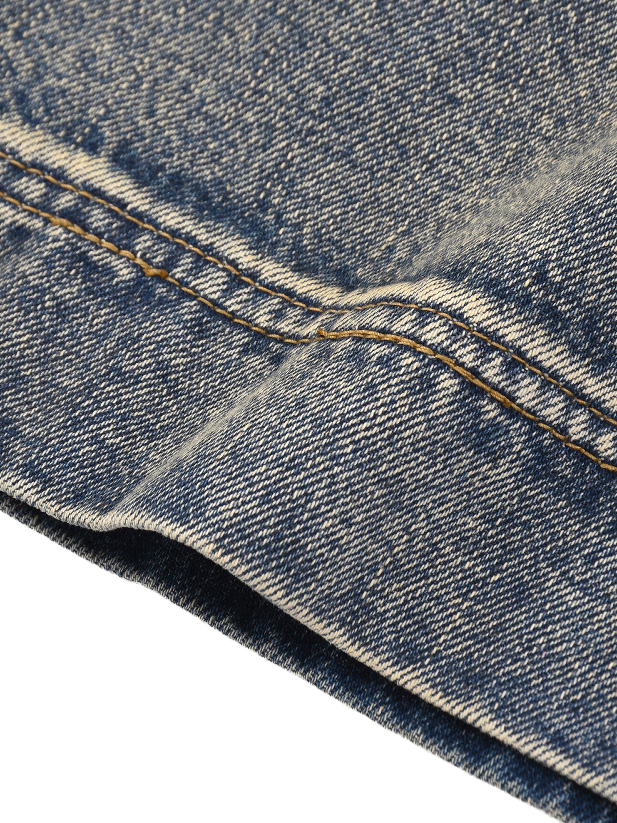 Close-up of vintage wash baggy denim shorts fabric and stitching detail