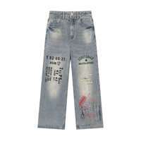 Vintage wash distressed denim jeans with graphic text prints and straight leg fit