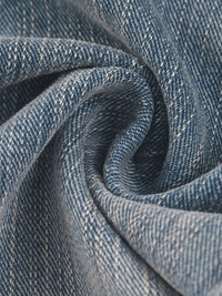 Close-up of vintage wash distressed denim jeans fabric