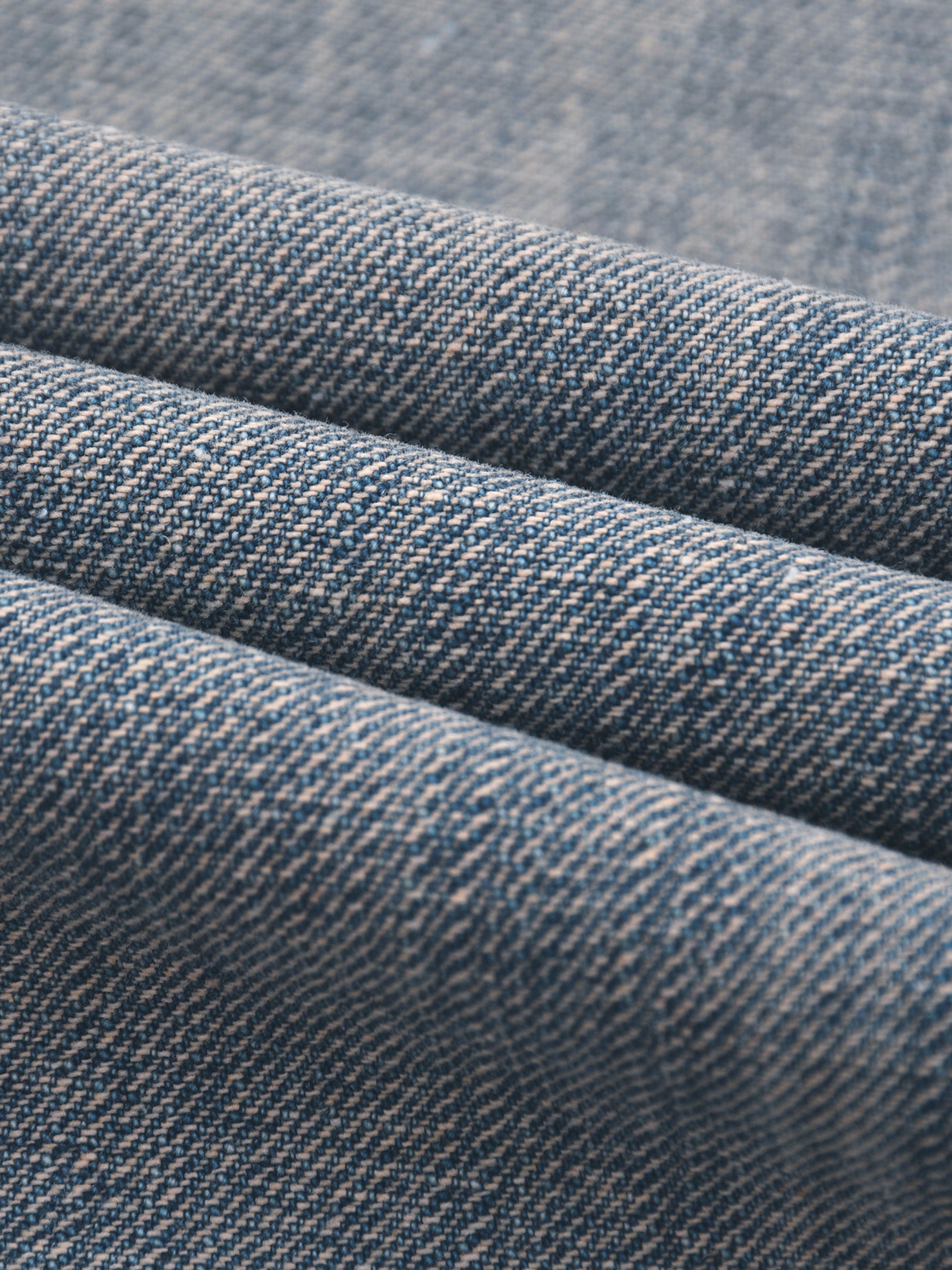 Close-up of blue vintage wash distressed denim fabric texture