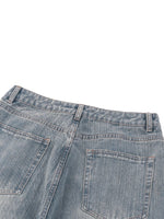 Back view of vintage wash distressed denim jeans with rear pockets and belt loops