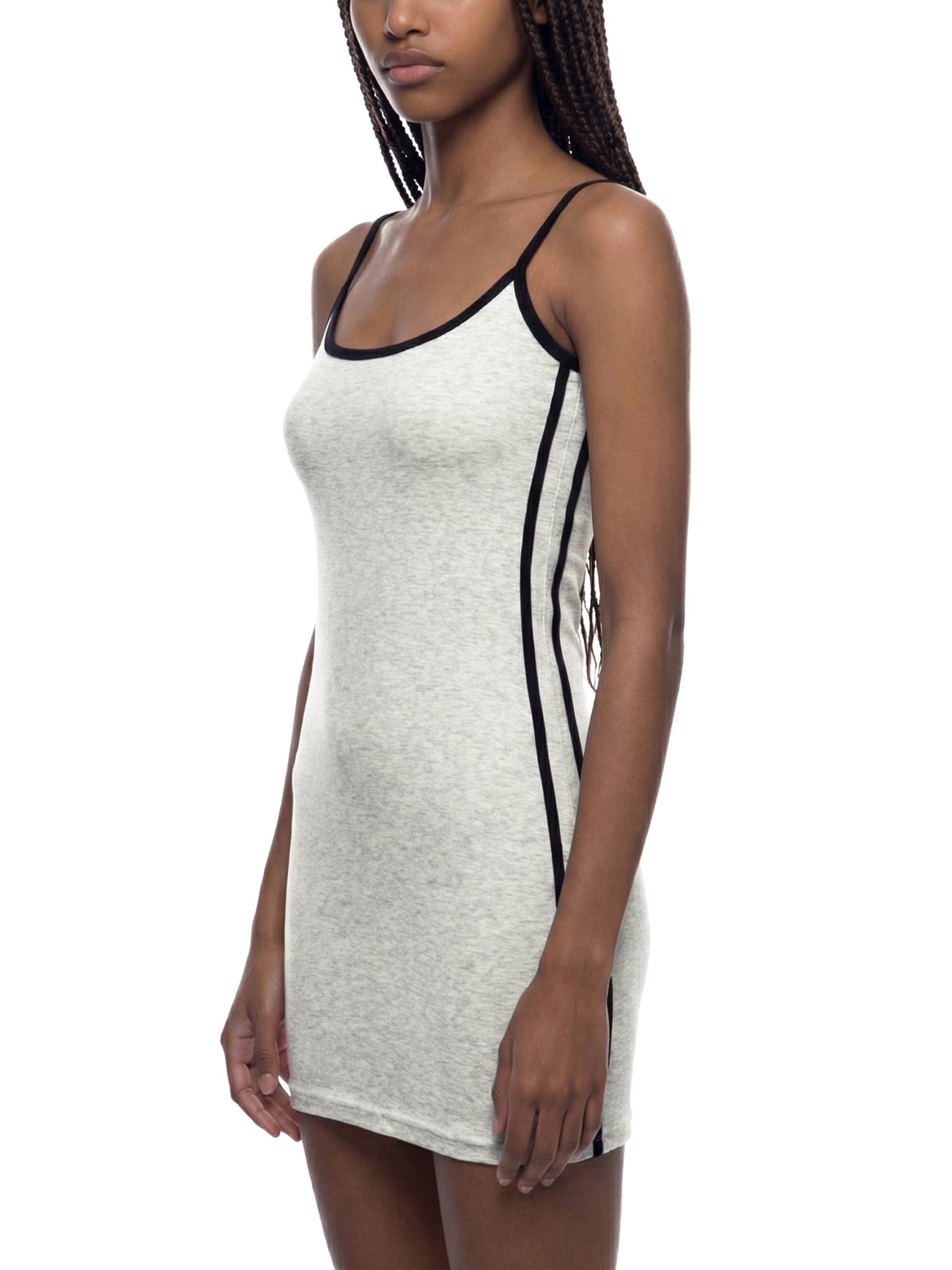 Woman wearing a grey color block mini dress with black trim and spaghetti straps