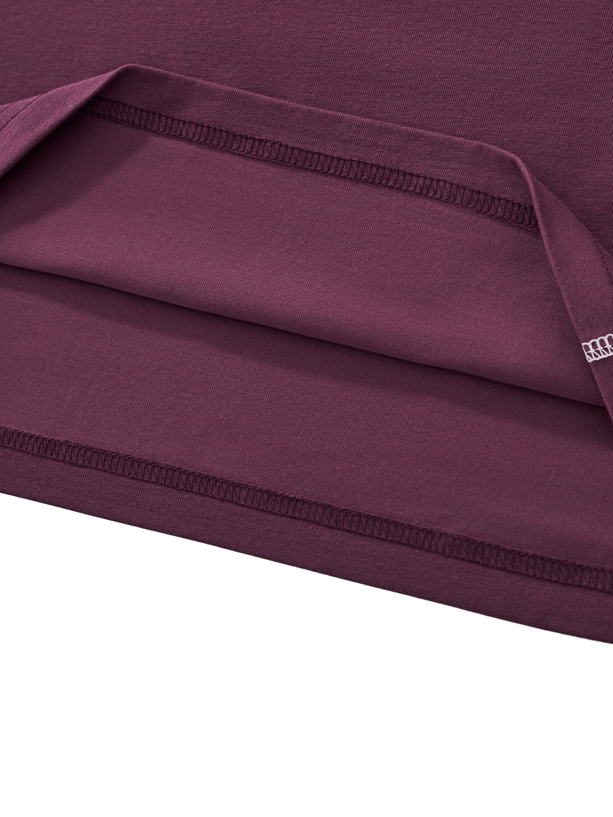 Close-up of maroon contrast stitch raglan crop t-shirt fabric and detailed stitching