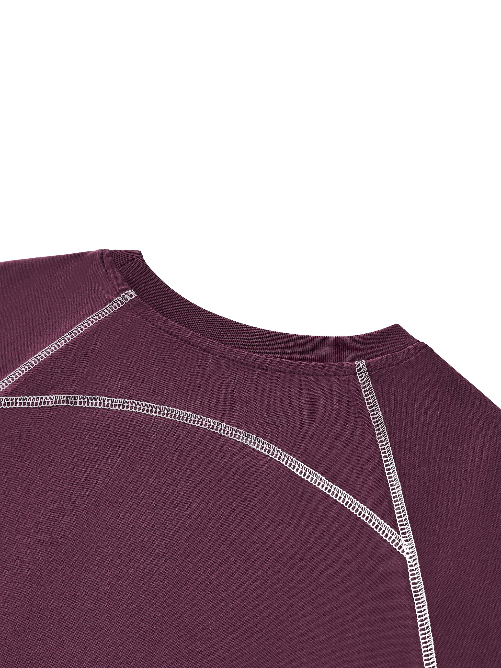 Closeup of women's purple raglan crop t-shirt with white contrast stitching