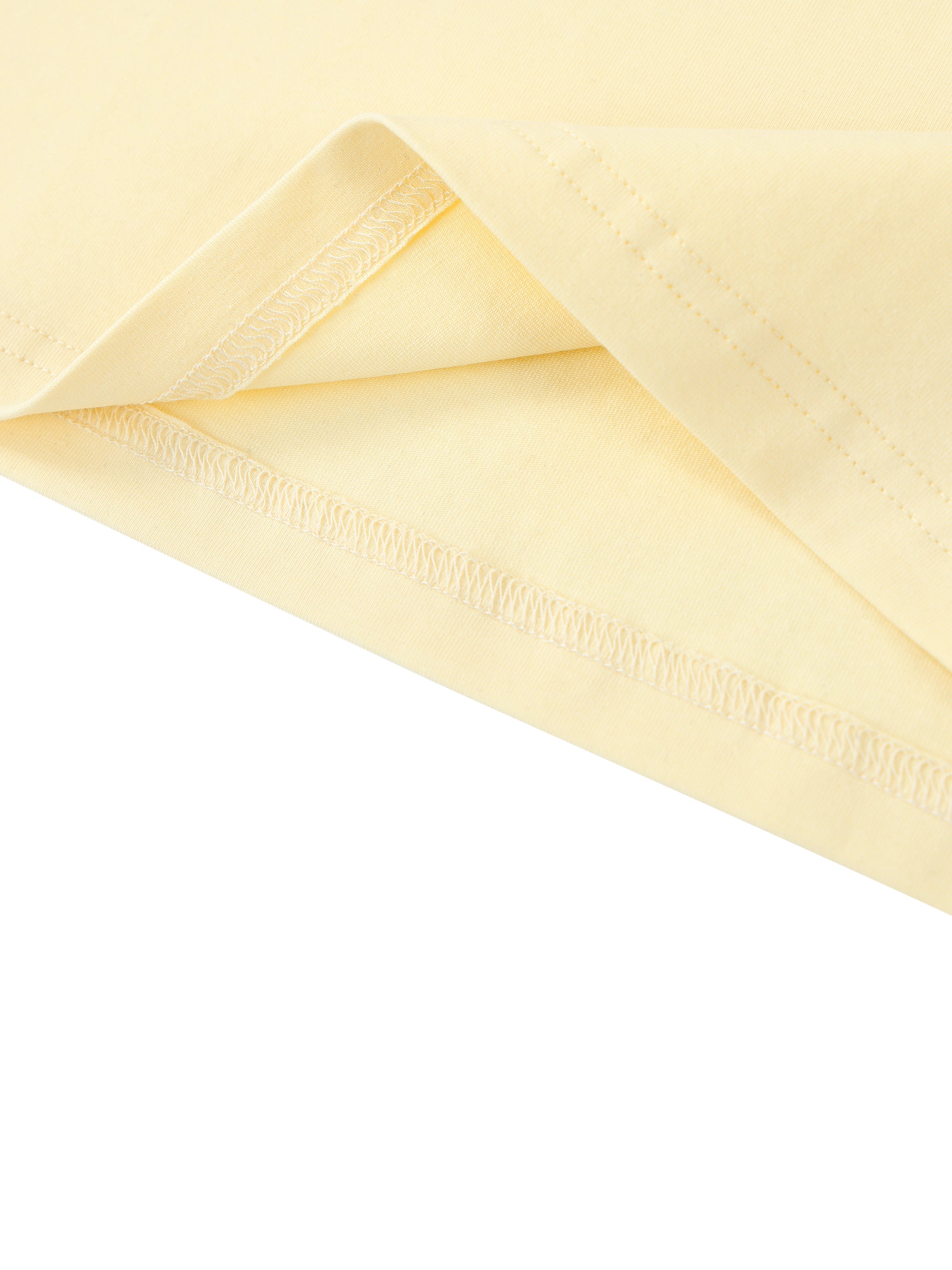 Close-up of pastel yellow heavyweight t-shirt fabric with contrast stitching detail