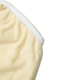 Close-up of beige women's cropped tube top with textured fabric and white elastic trim