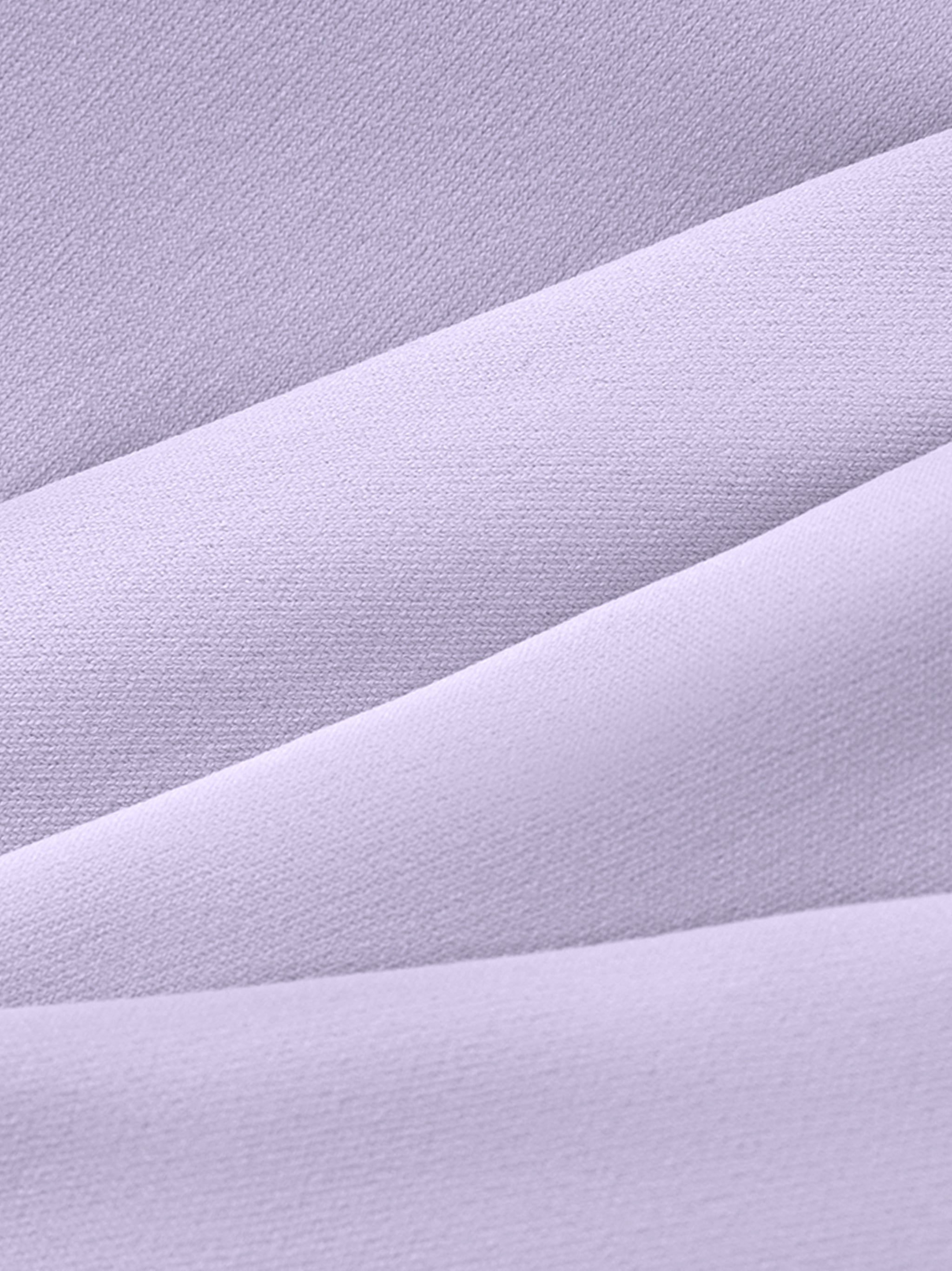 Close-up of soft lavender athletic fabric with visible texture and layered folds.