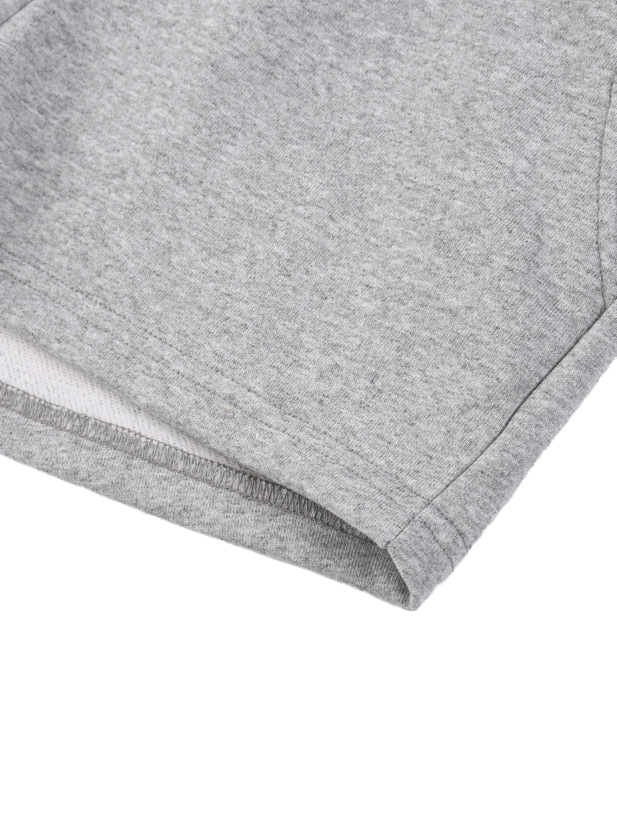 Close-up of light grey women's drawstring shorts hem, soft cotton fabric texture