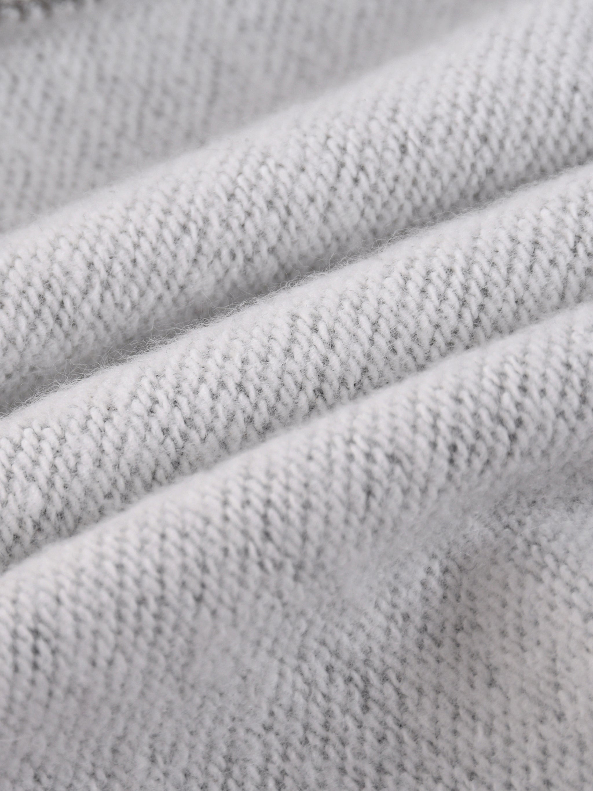 Close-up of soft, heavyweight knit grey fabric texture, ideal for premium apparel