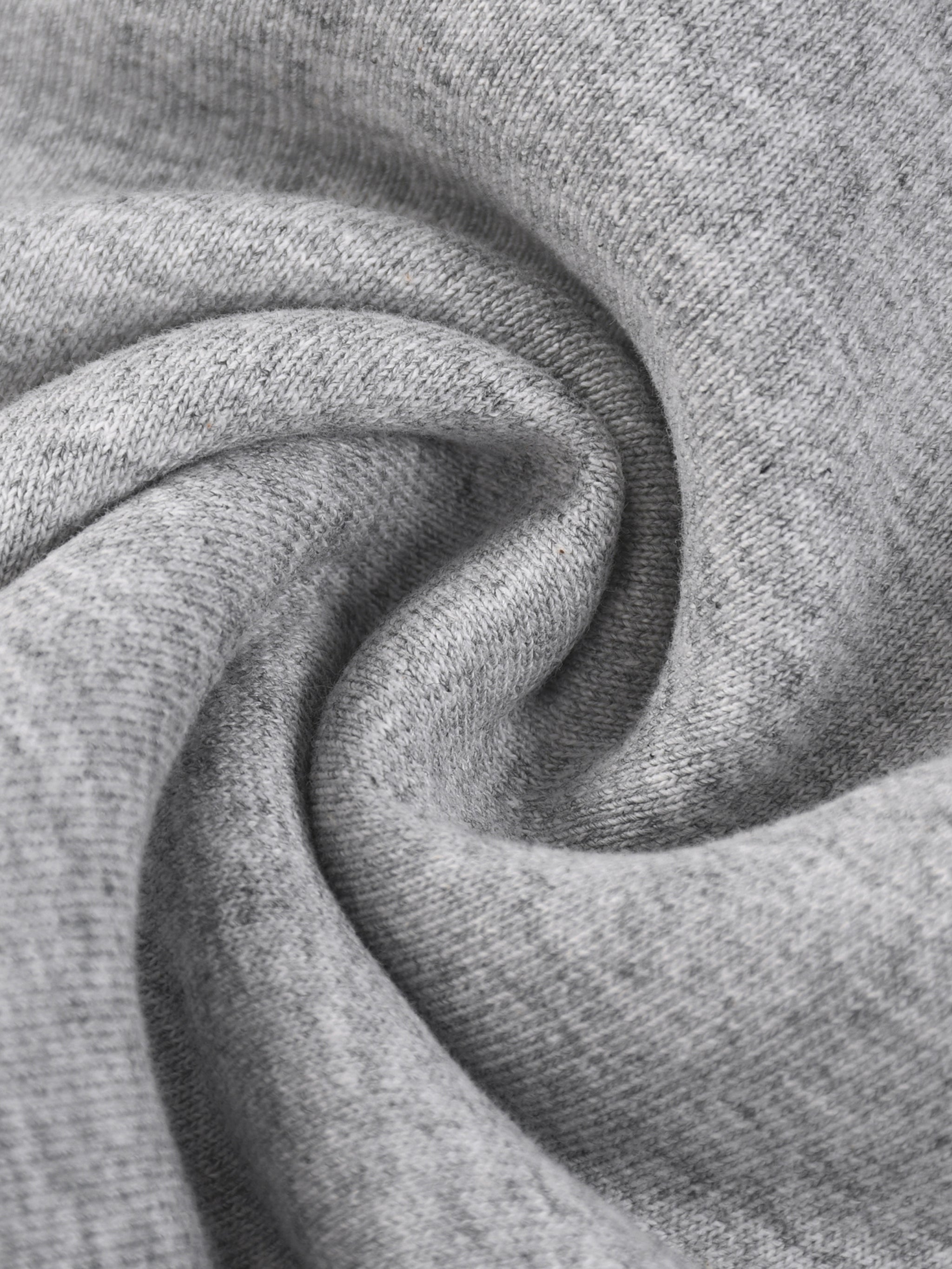 Close-up of soft heather gray knit fabric, showcasing texture and quality material
