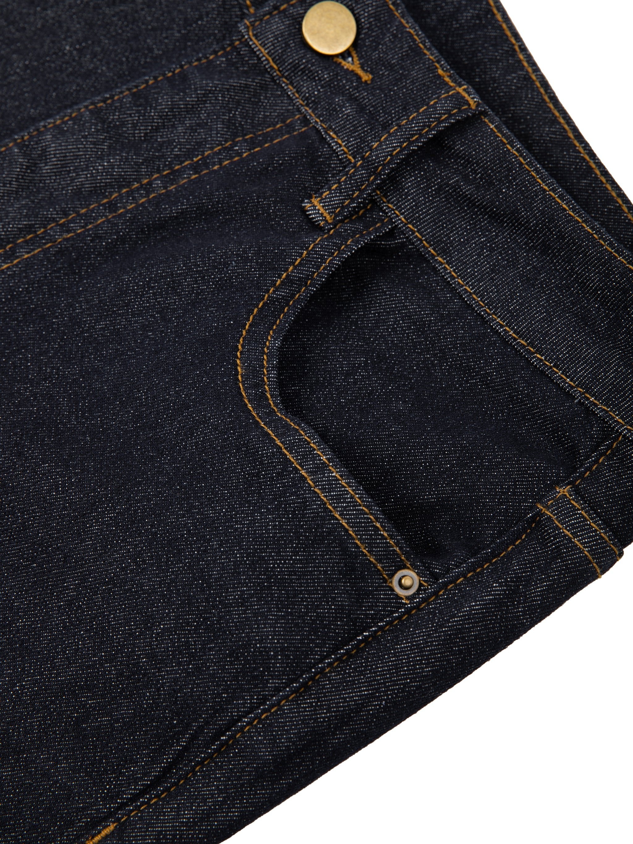 Close-up of women's high-rise skinny jeans in dark denim with gold stitching and rivets