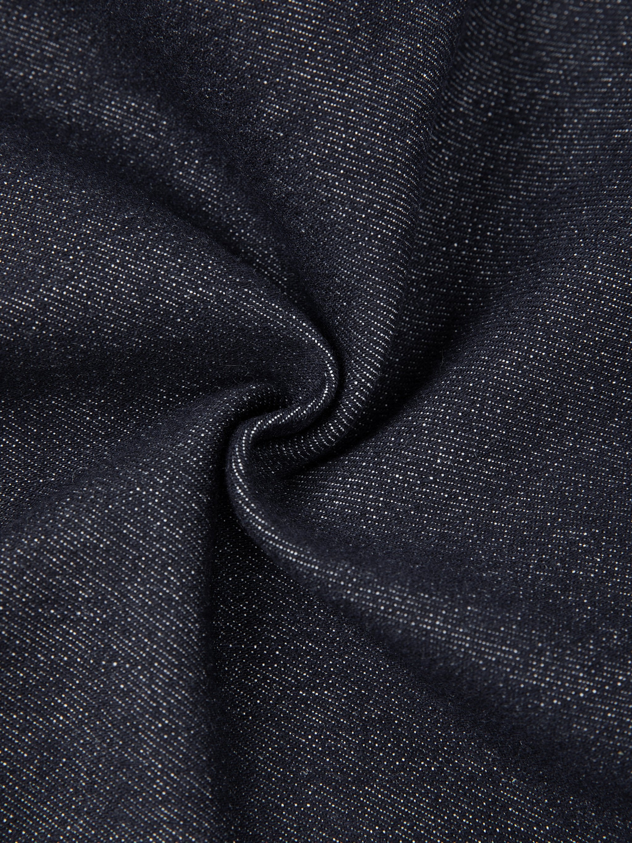 Close-up of dark blue denim fabric texture with visible weave, ideal for skinny jeans