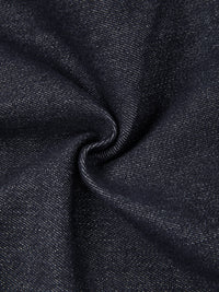 Close-up of dark blue denim fabric texture with visible weave, ideal for skinny jeans