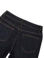 Close-up of women's high-rise skinny jeans back pockets in dark denim