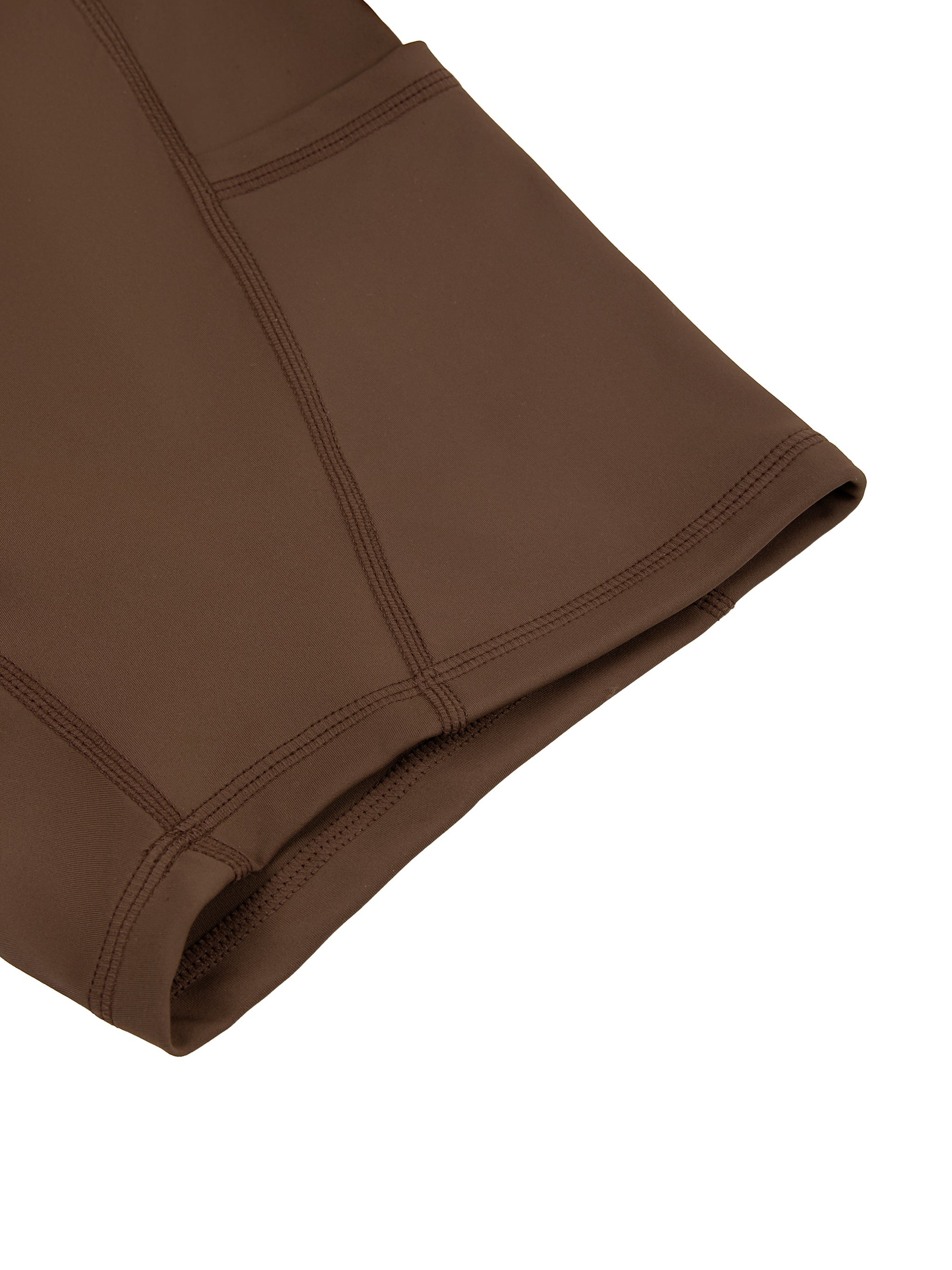 Close-up of brown women's high-waisted pocket biker shorts showing stitching detail