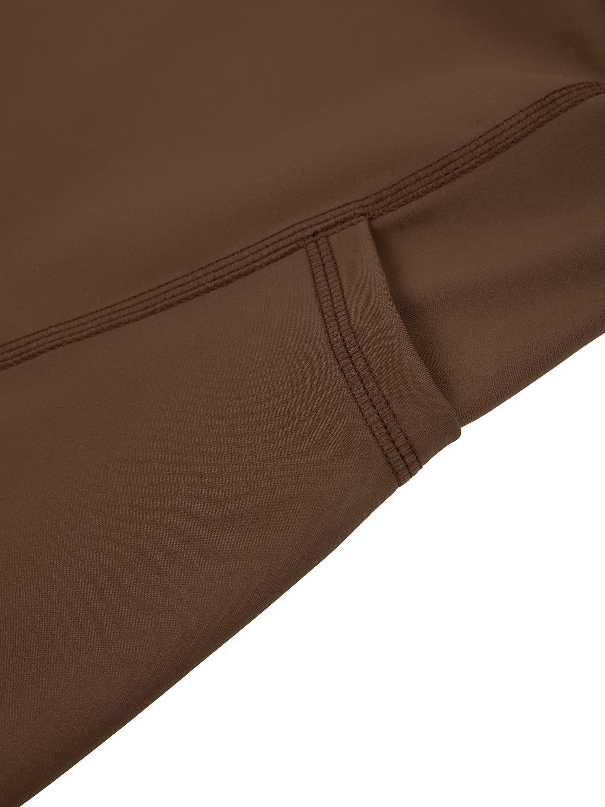 Close-up of brown high-waisted biker shorts with visible pocket and stitching details