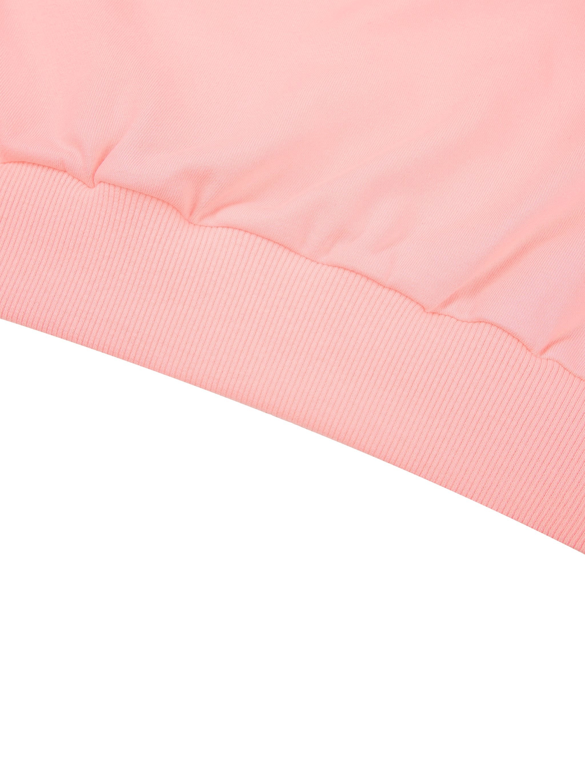 Close-up of pink off-shoulder sweatshirt hem with ribbed knit detailing