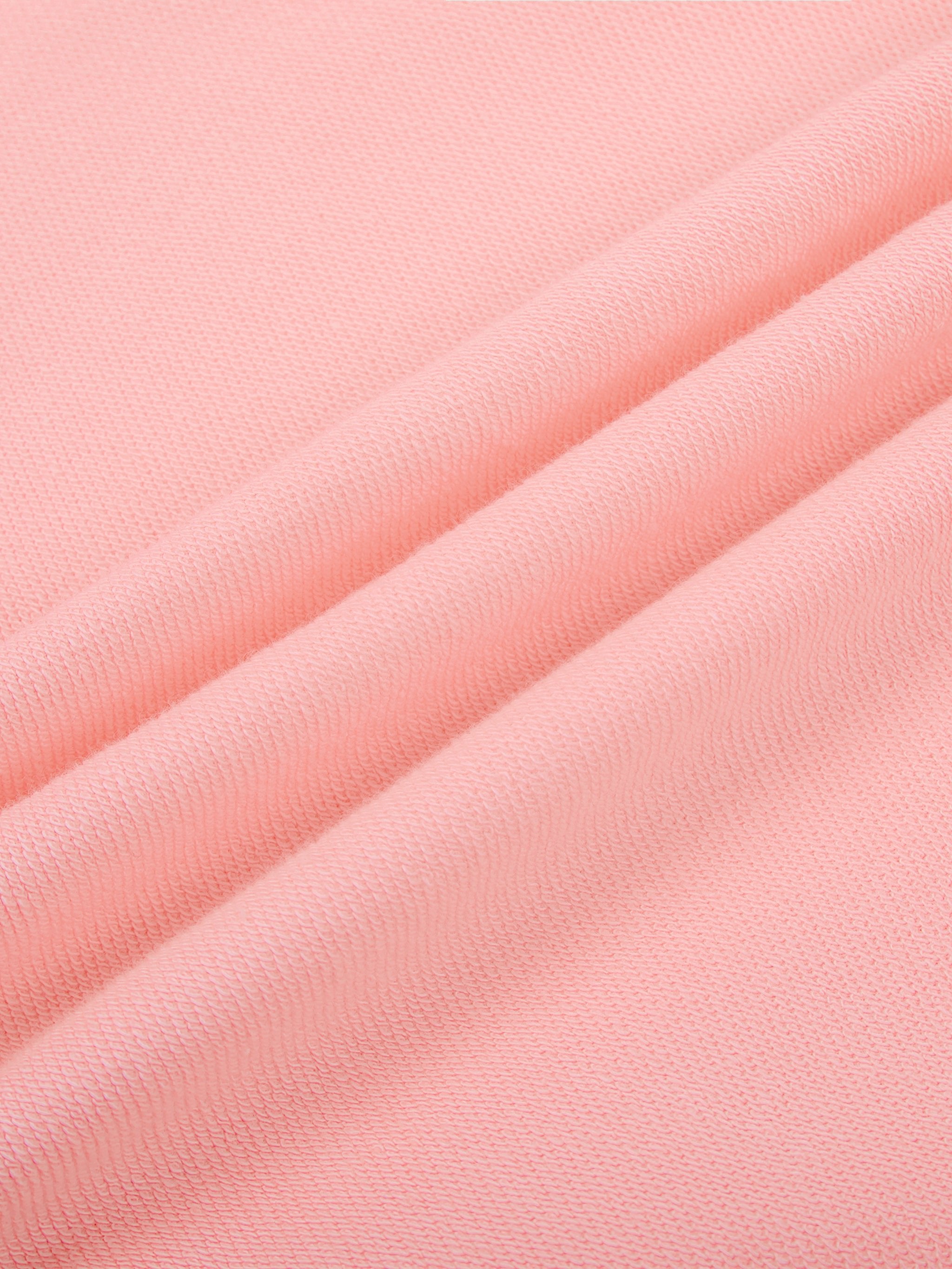 Soft pink heavyweight knit fabric close-up, textured streetwear material